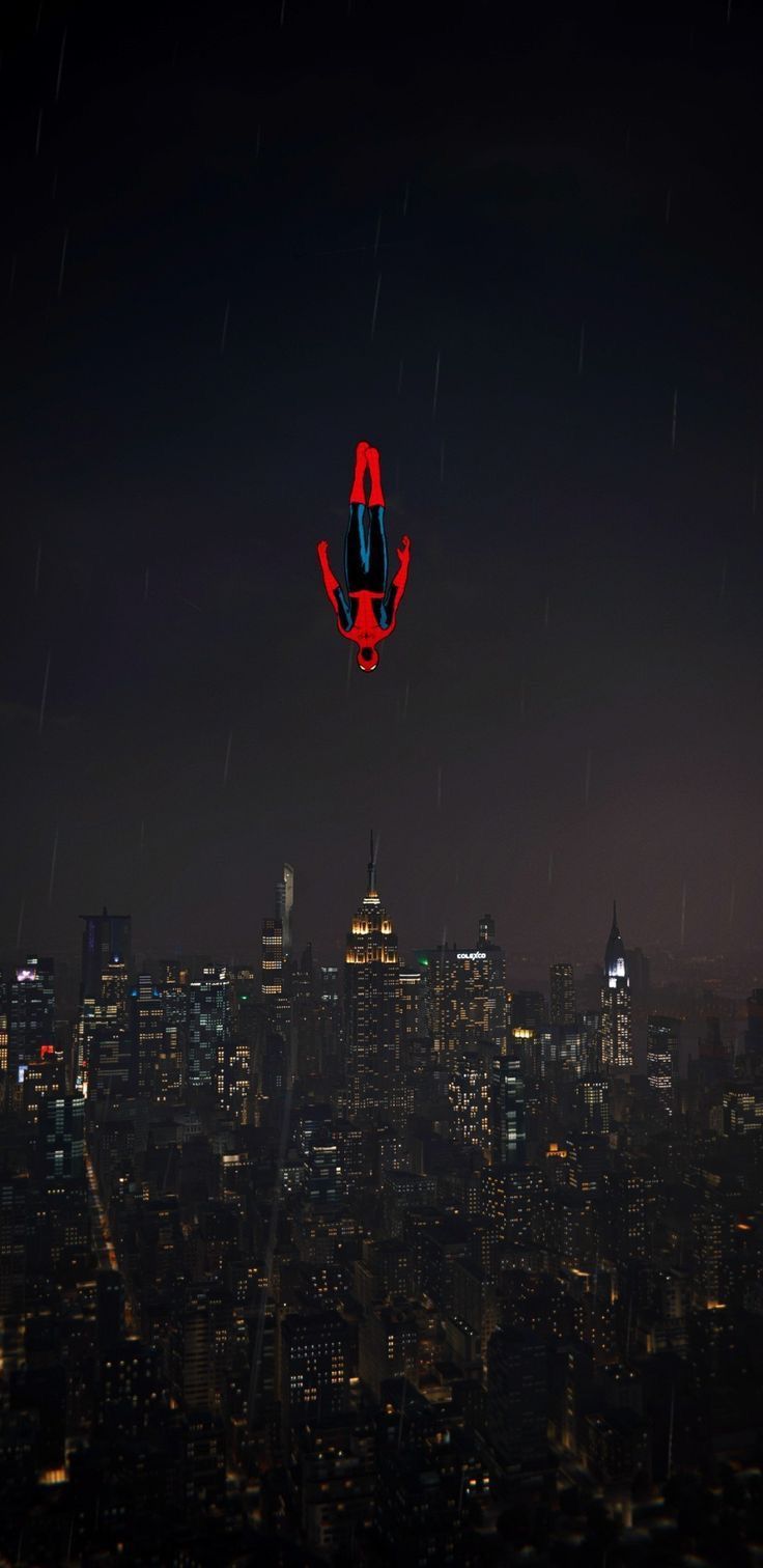 736x1512 Spider Man Wallpaper: An Airplane Flying Over A City At Night. Tuff Spiderman Wallpaper, Spider Man Background Aesthetic, Spiderman Falling Wallpaper