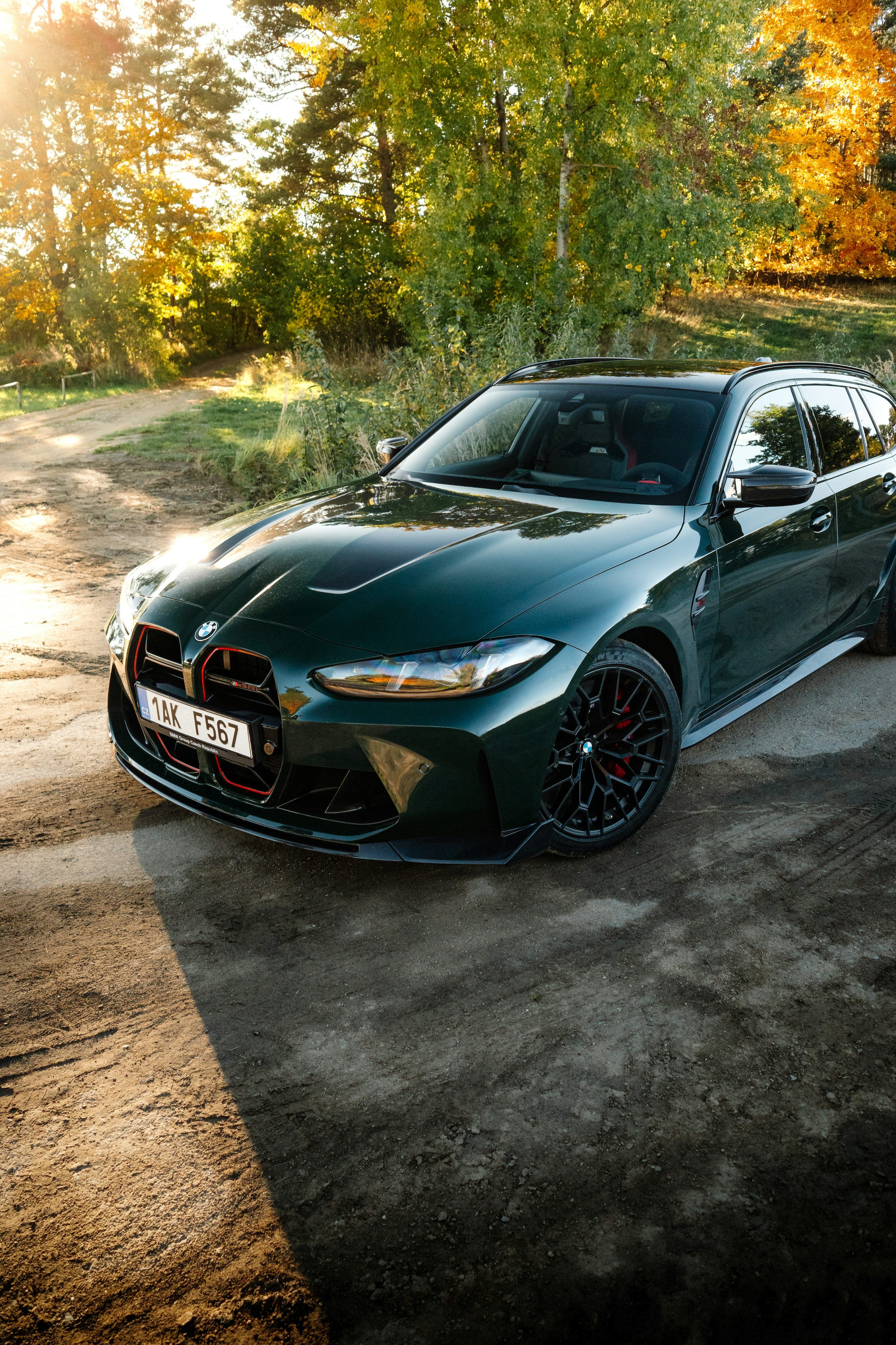 3000x4500 Dark green station wagon parked on a dirt road