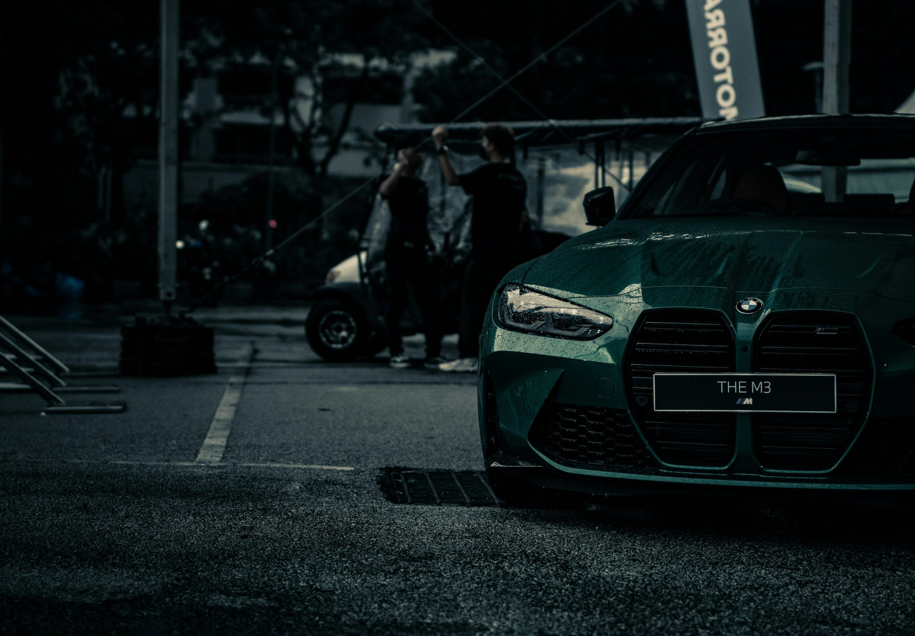 3000x2085 A green sports car parked in a parking lot