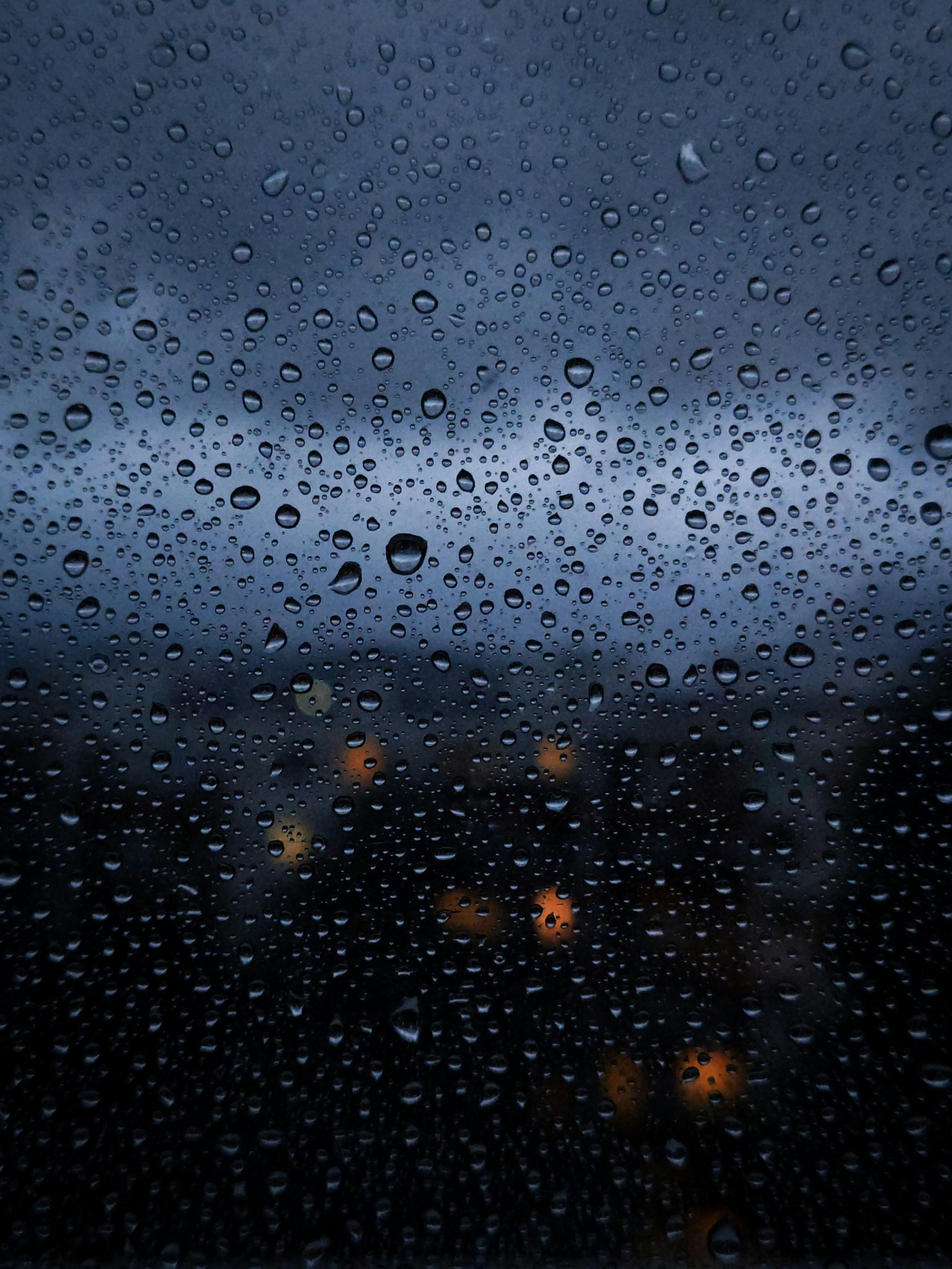 3000x4000 Rain drops on a window with a dark sky in the background
