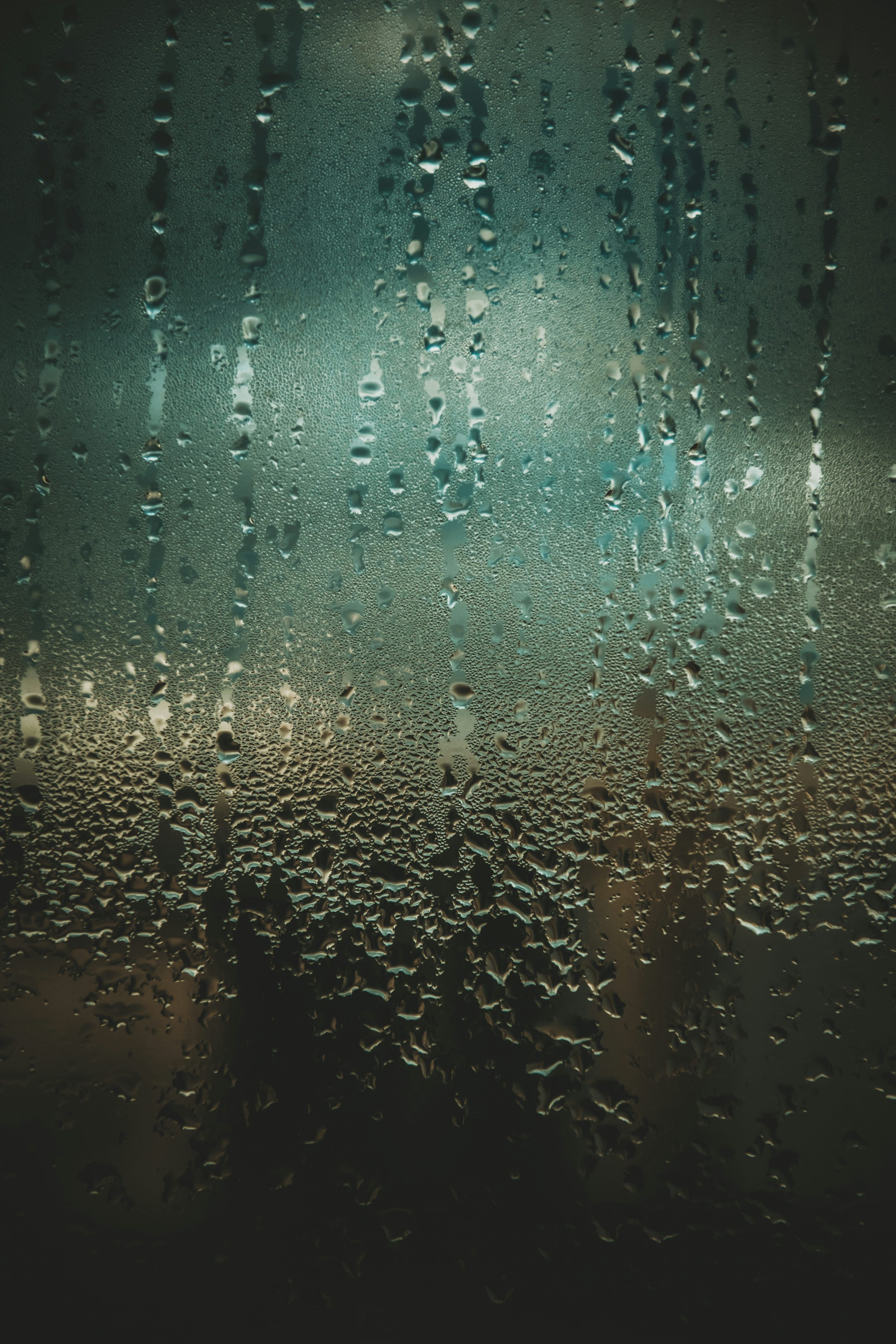 3000x4500 Rain drops on a window with a dark background