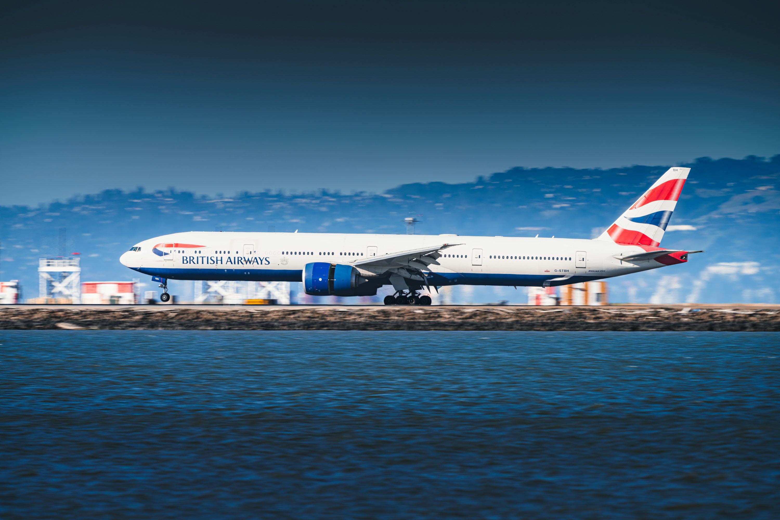 3000x2000 British airways airplane on tarmac by the water photo