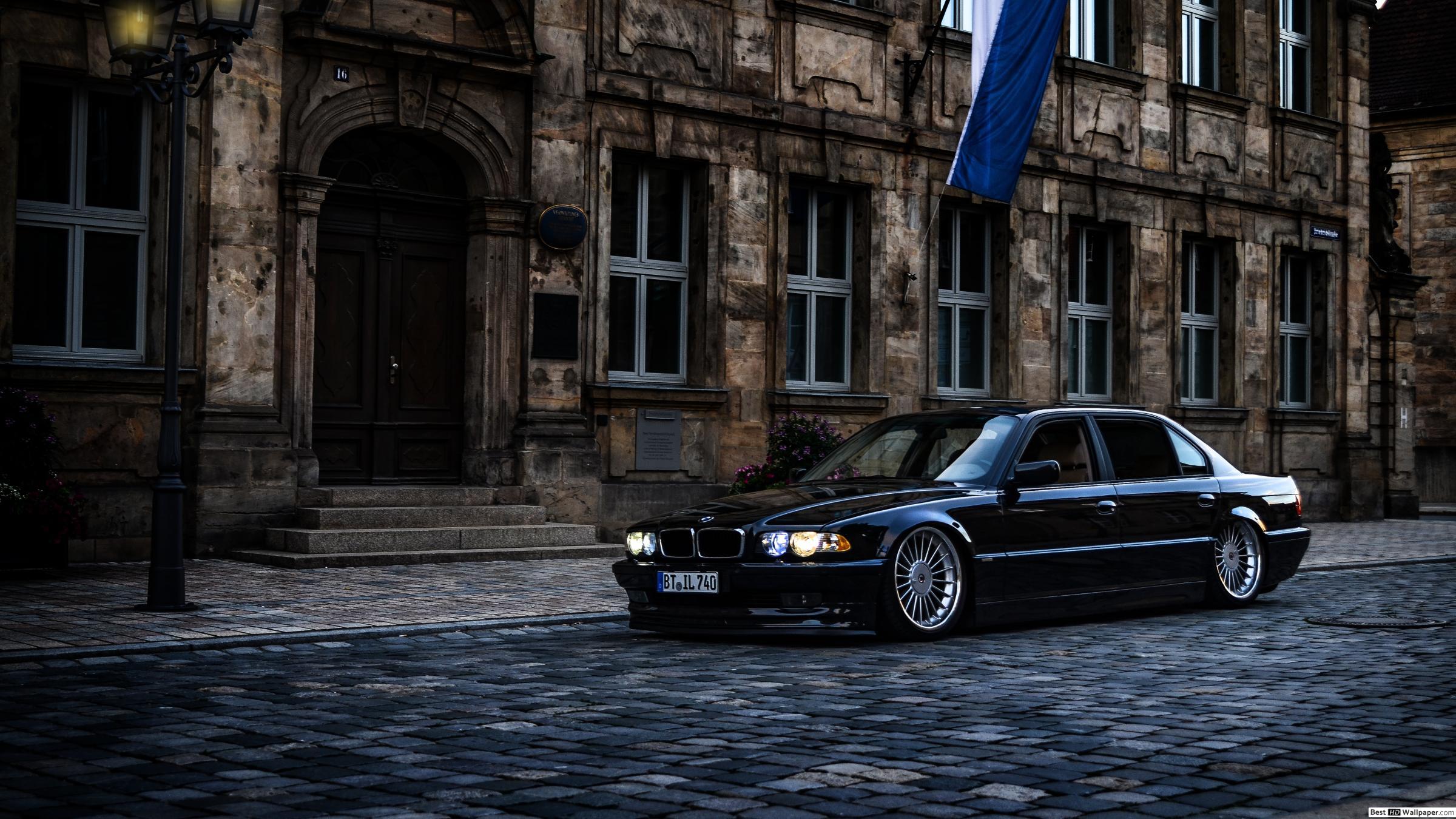 2400x1350 Black BMW sedan parked near house HD wallpaper download