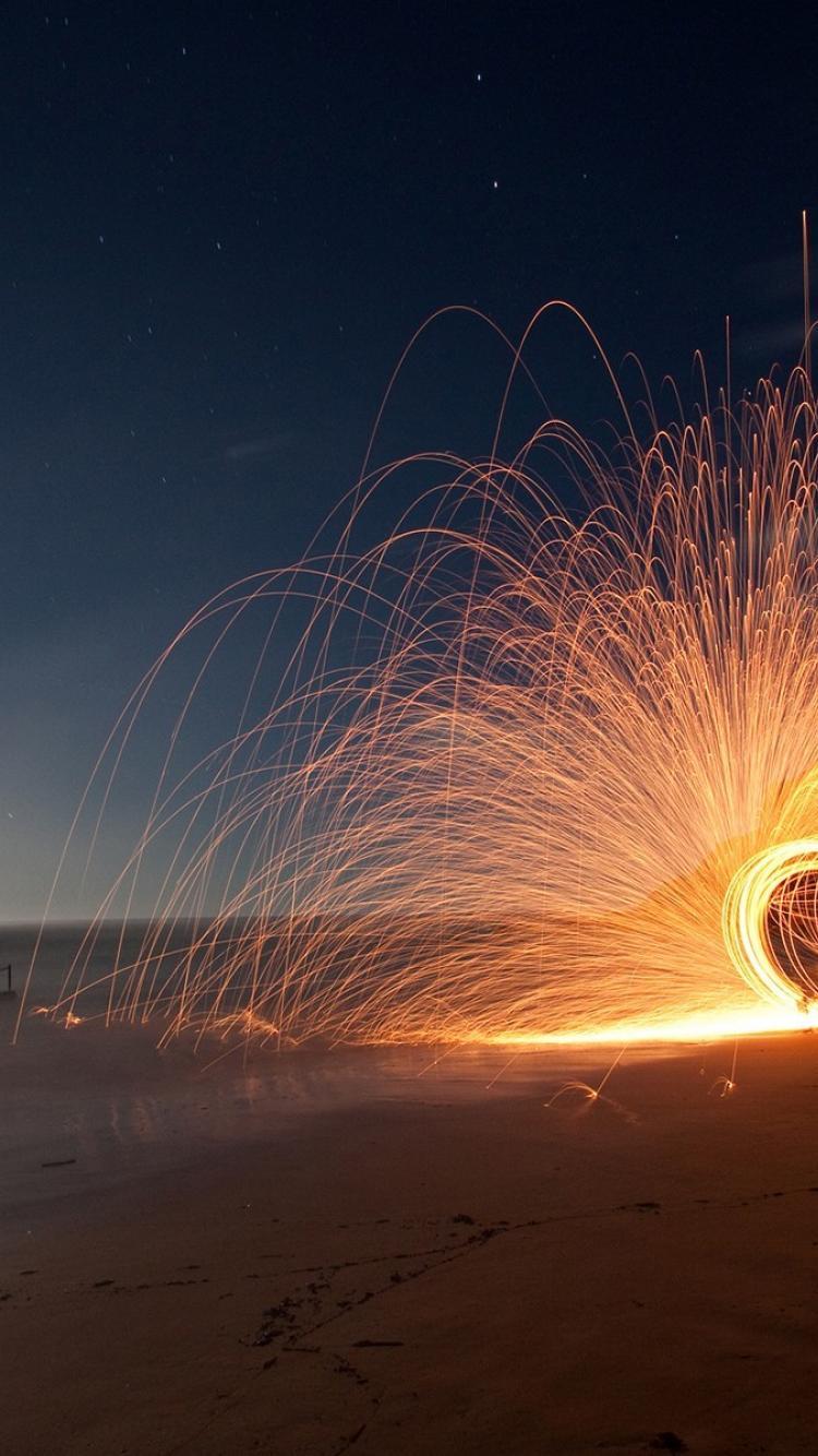 750x1334 Beach night sparks time lapse wallpaper .
