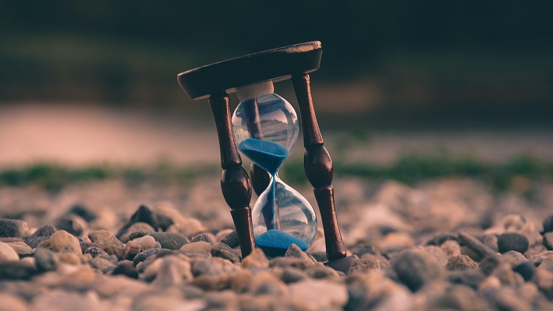 1920x1080 Download wallpaper 1920x1080 hourglass, stones, blur full hd, hdtv
