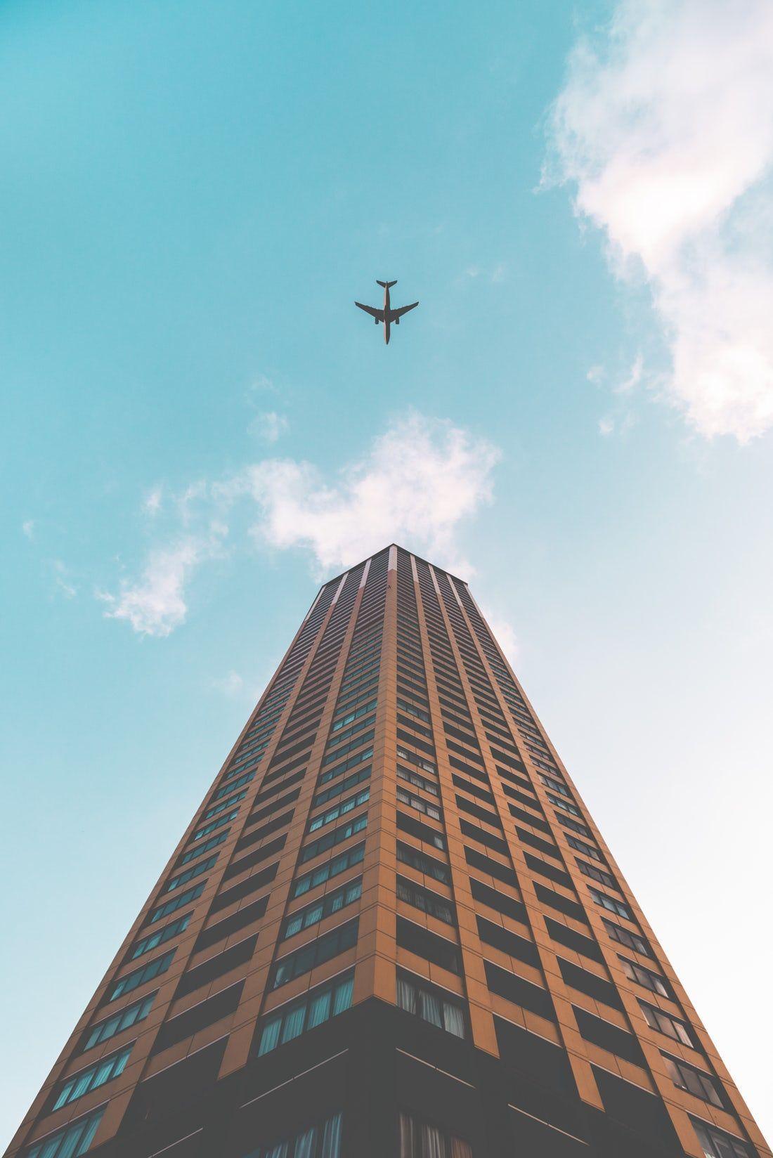 1100x1648 bottom view shot of airplane flying .com
