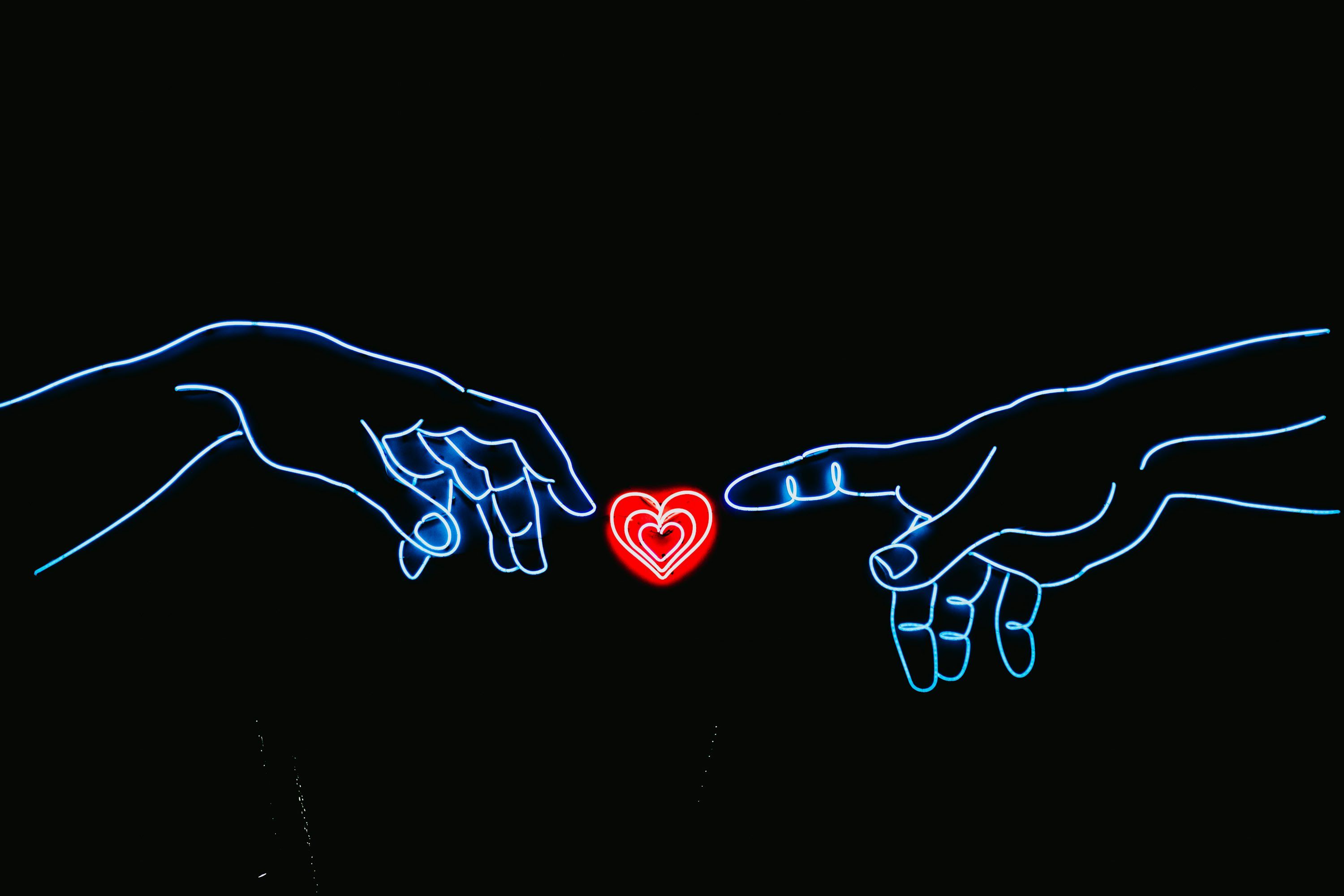 3000x2000 Neon light photo of two hands touching red heart