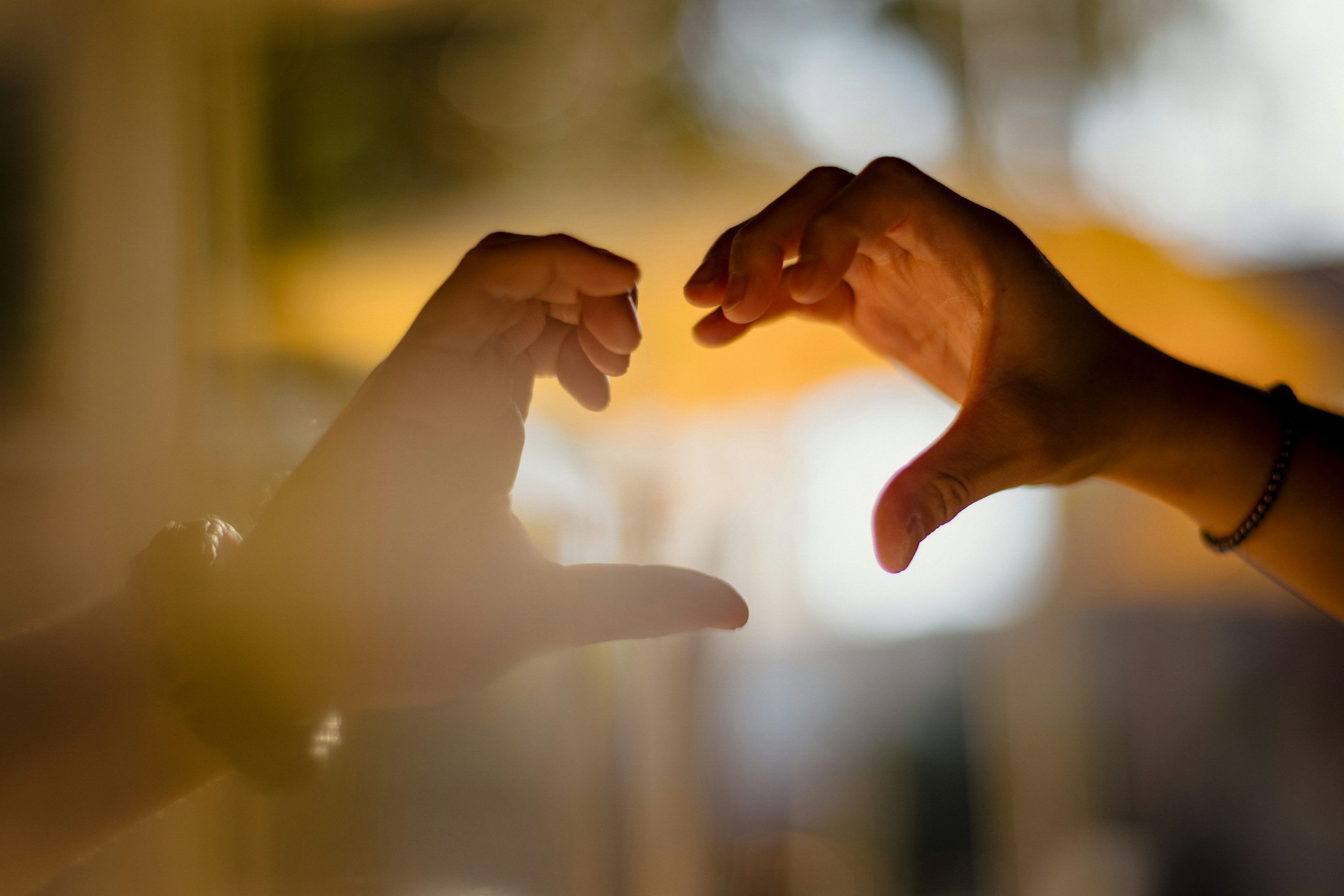 3000x2000 Two people reaching out their hands to touch each other
