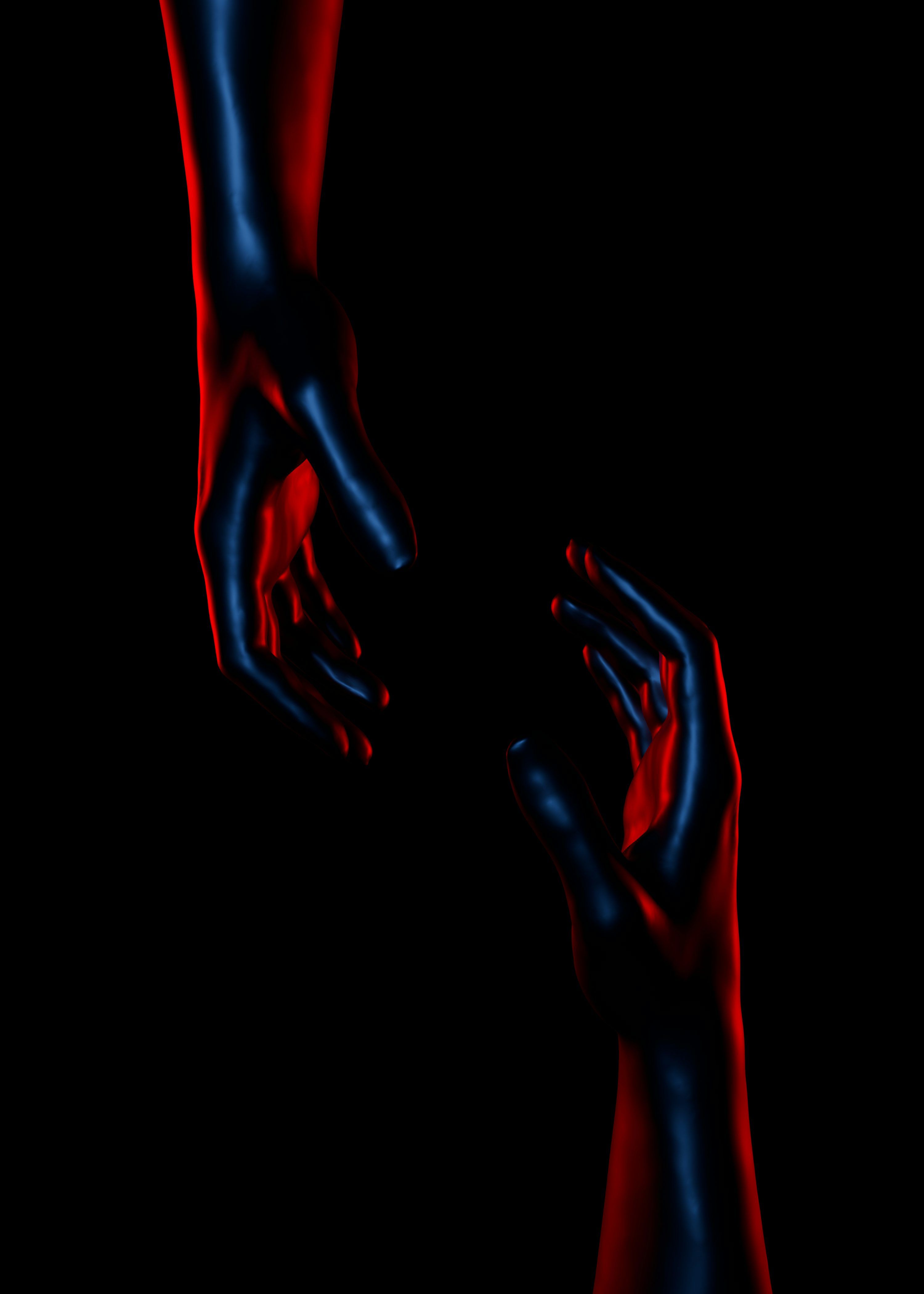 3000x4200 Two hands touching each other in the dark