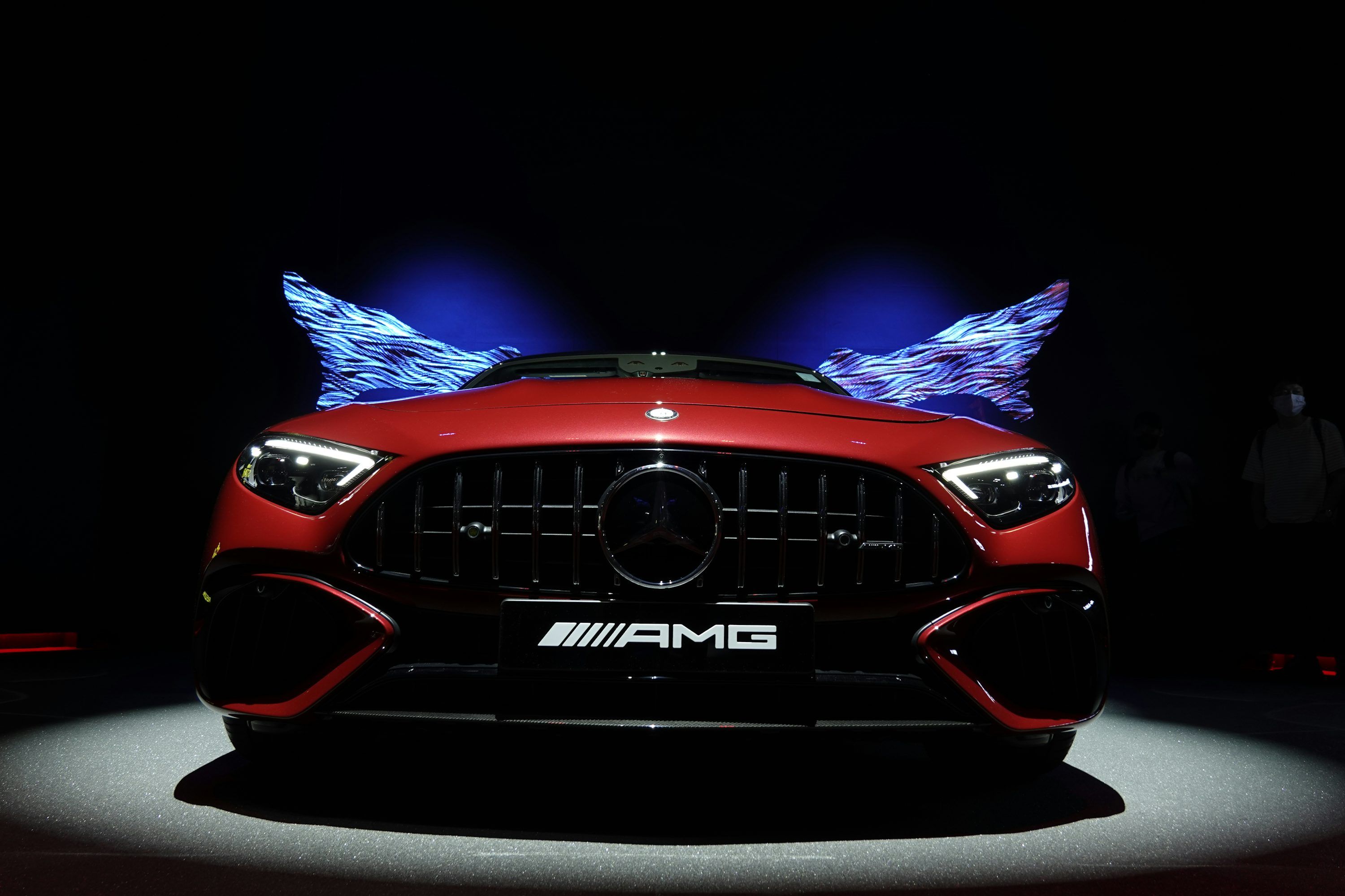 3000x2000 A red mercedes amg car on display at a show