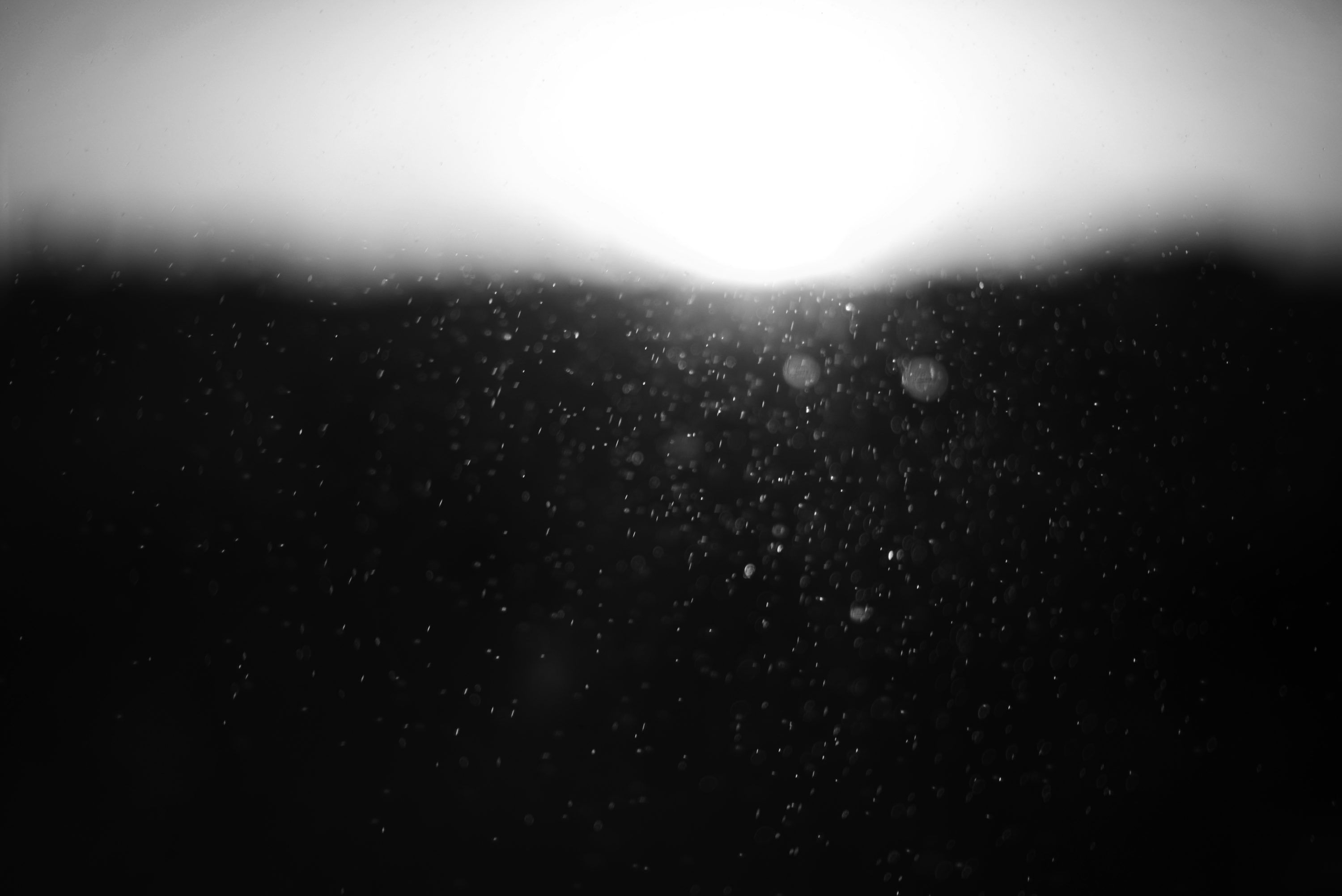 3000x2003 Abstract dark background with bright light and particles