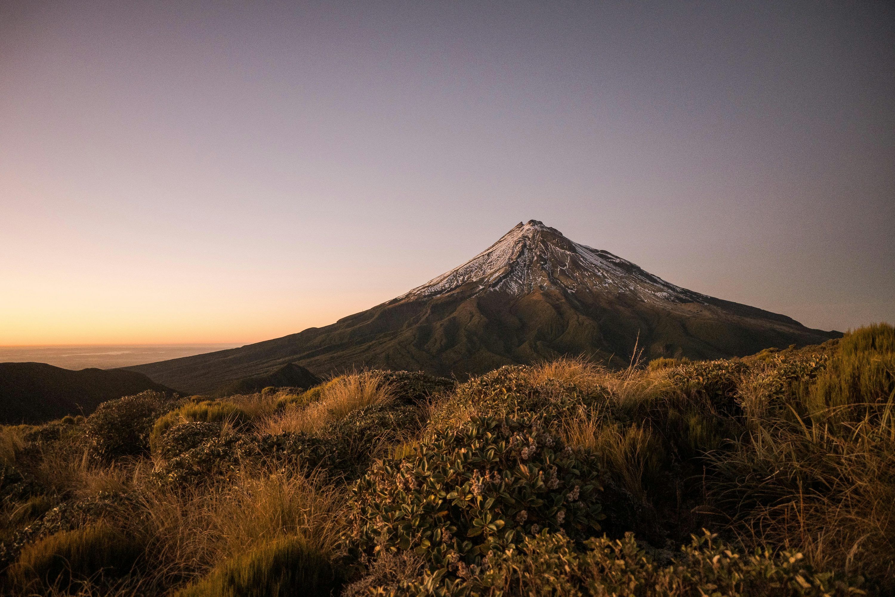 3000x2000 A snowy mountain peak looms under the dusky sky