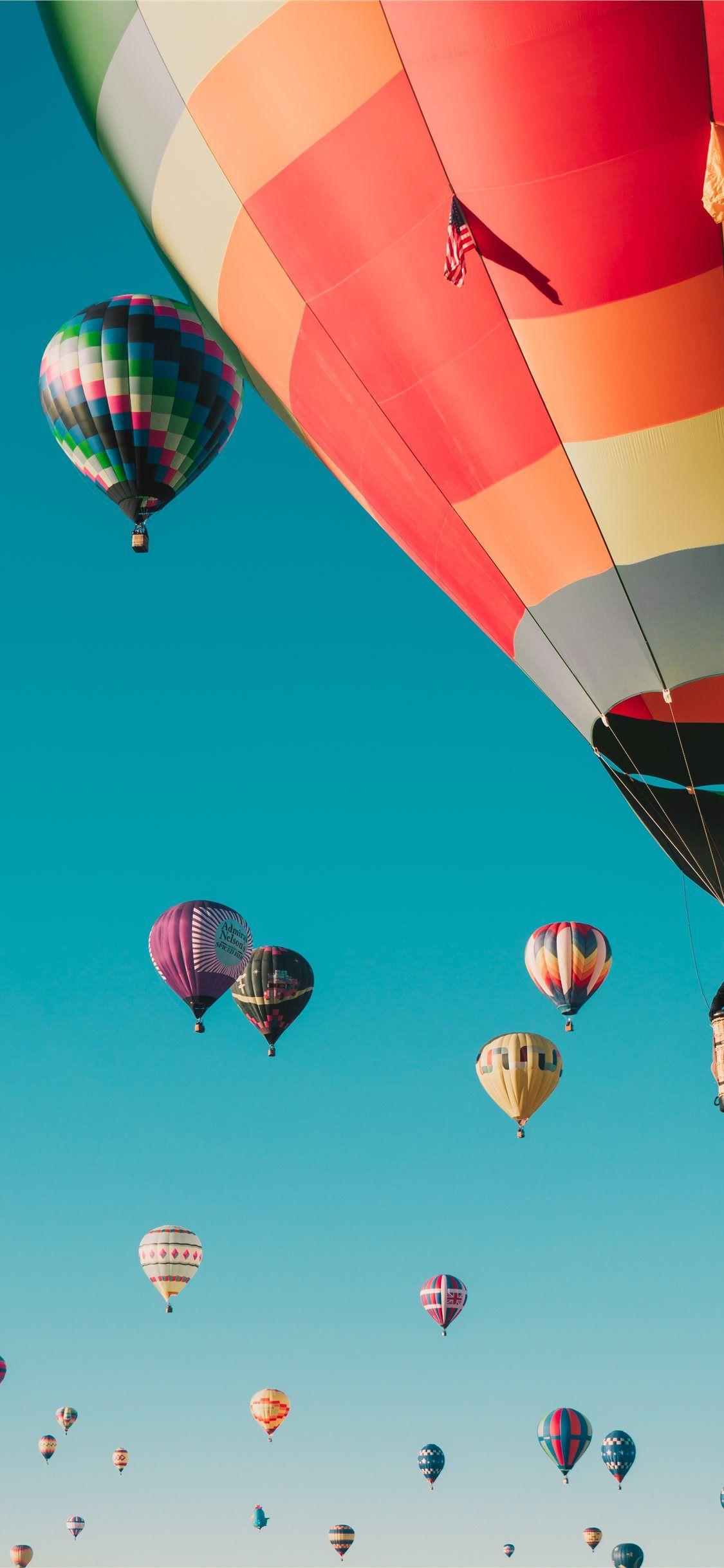 1125x2436 hot air balloons under blue sky iPhone .