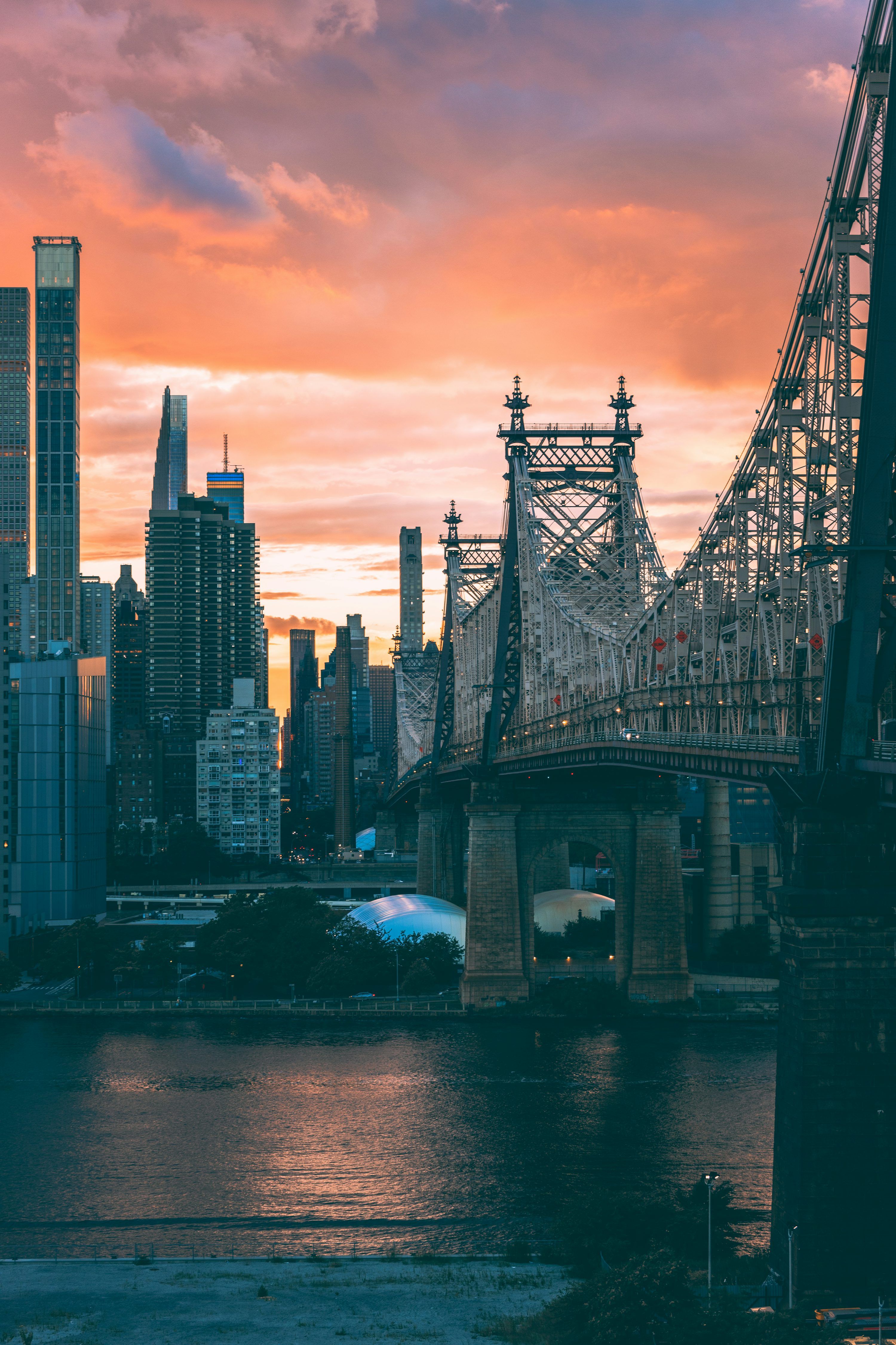3000x4500 A bridge over water with buildings in the background