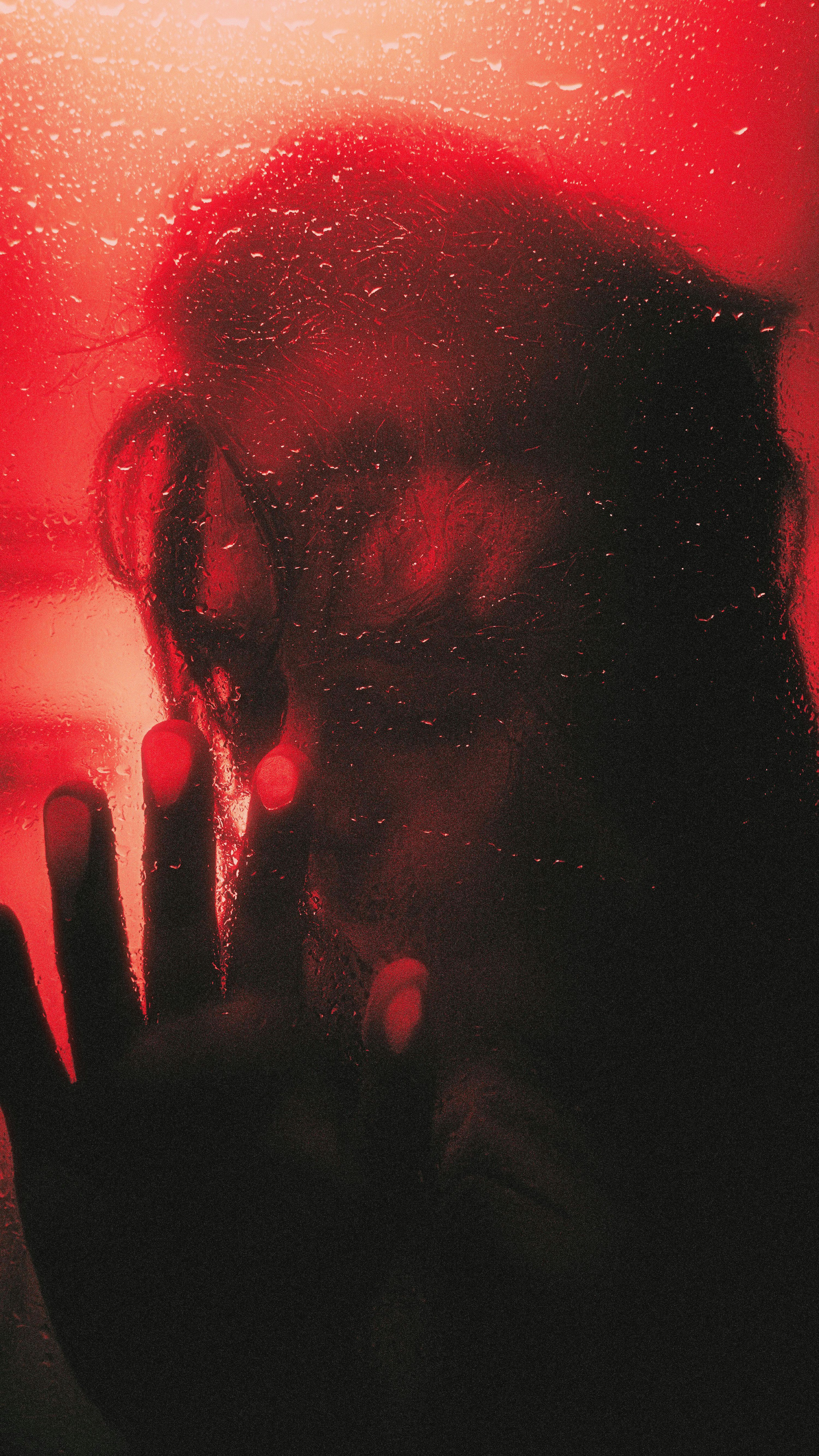 3000x5333 Silhouette of a person's face behind a wet surface