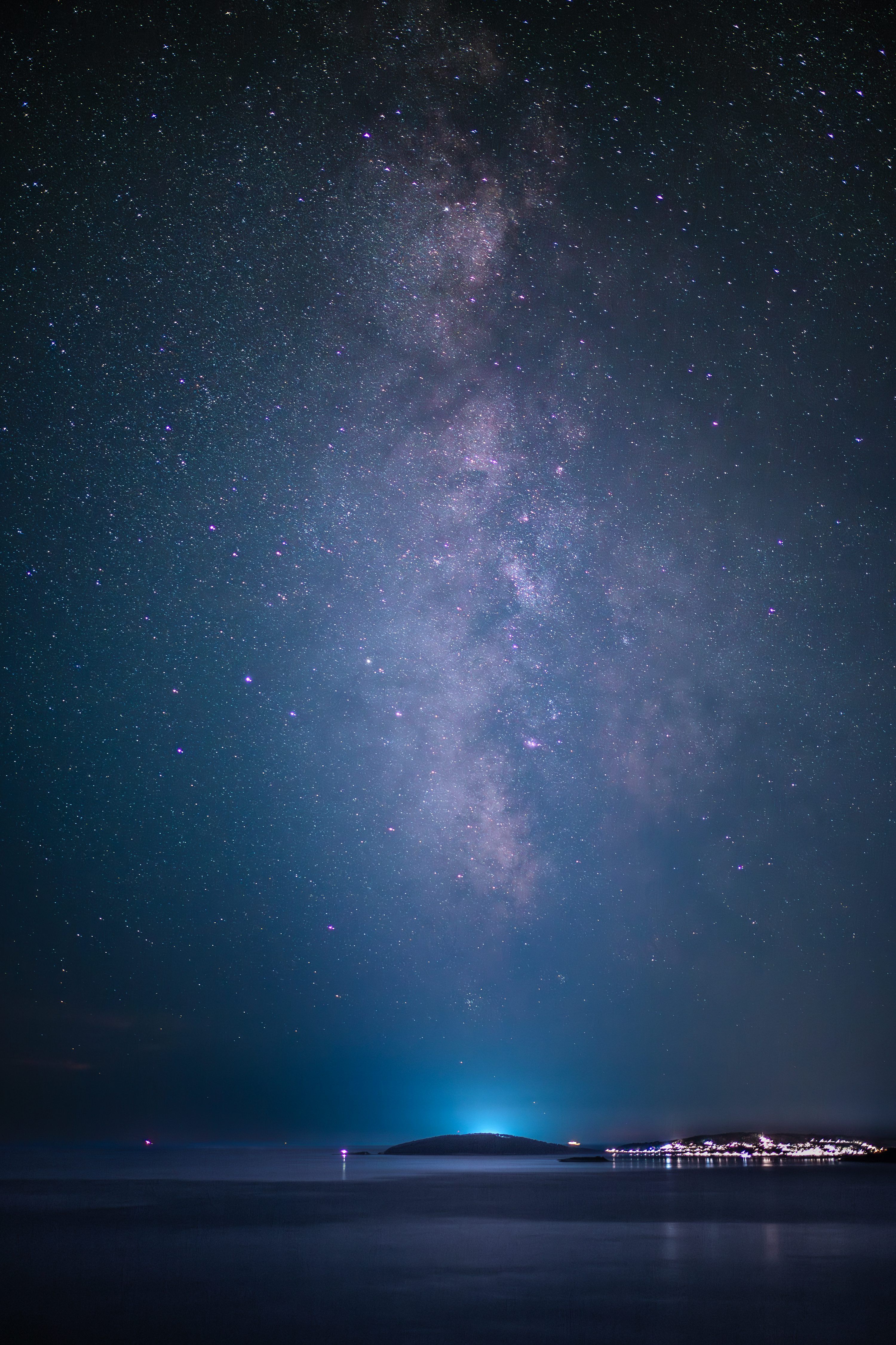 3000x4500 The milky way shines brightly above the ocean