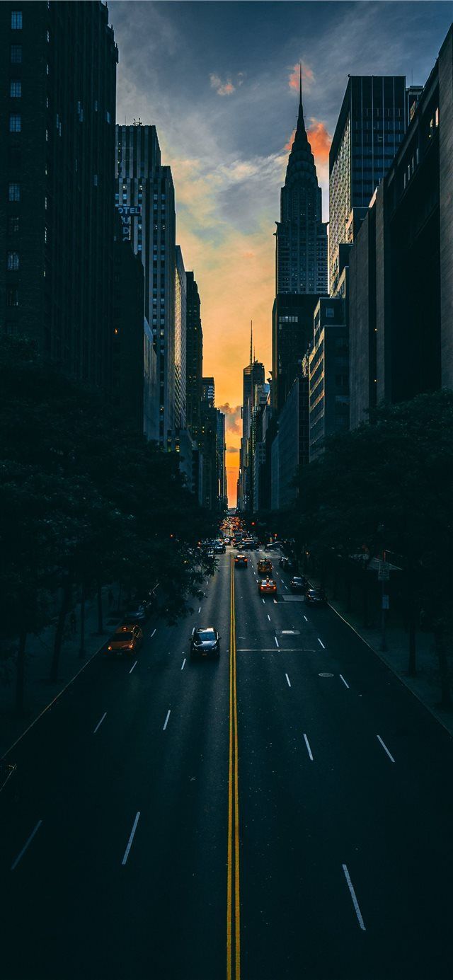 640x1385 low light photography of vehicle crossing road bet. iPhone X Wallpaper Free Download