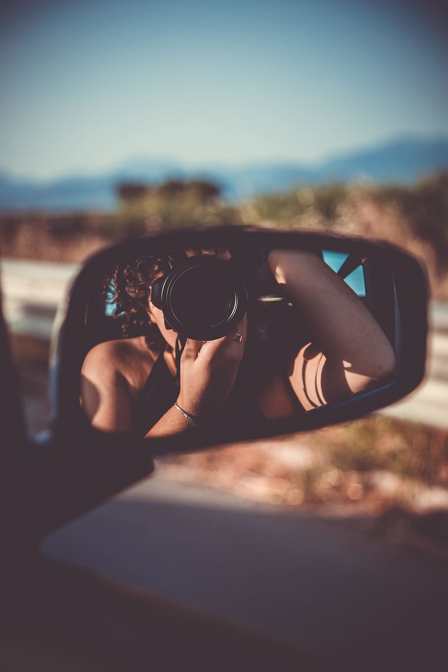 910x1365 HD wallpaper: person taking selfie through vehicle wing mirror, selective focus photography of car side mirror reflected the woman taking the picture using DSLR camera while inside the car