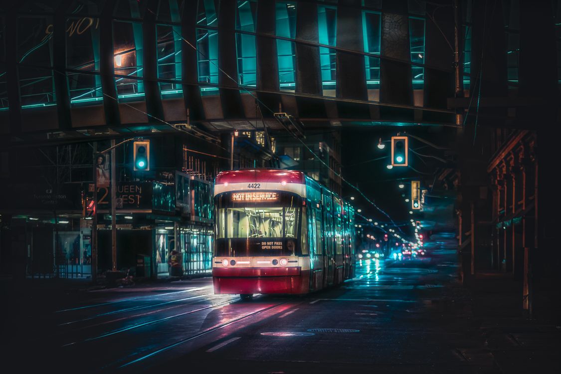 1125x750 A Red Streetcar Moving on the Road During Night Time · Free