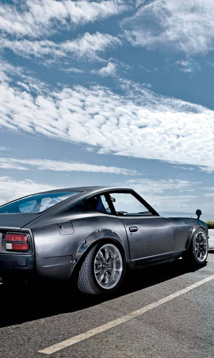 717x1200 Download Sleek and Stylish Datsun Car on the Road Wallpaper