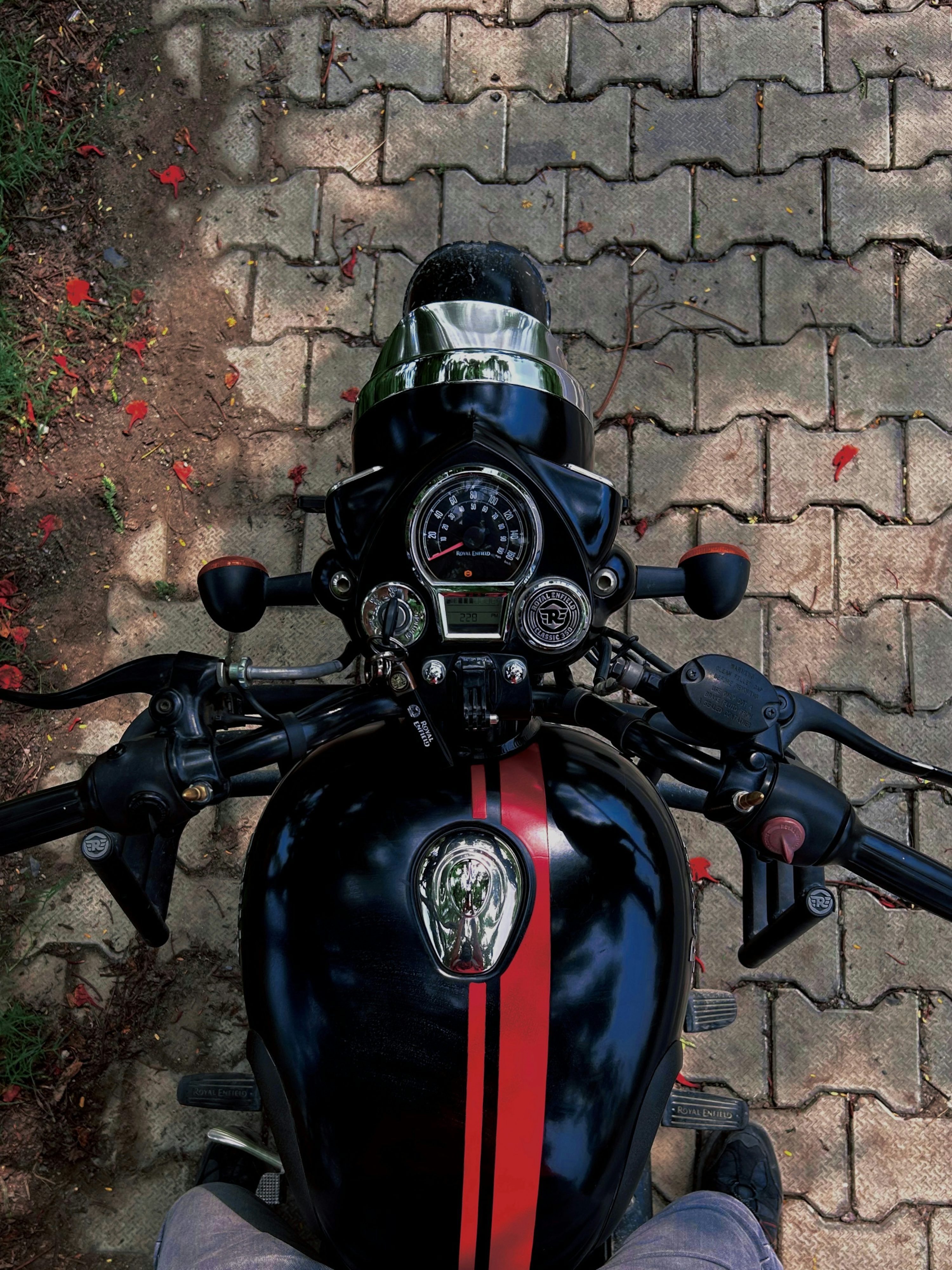 3000x4000 A person sitting on a motorcycle on a brick road