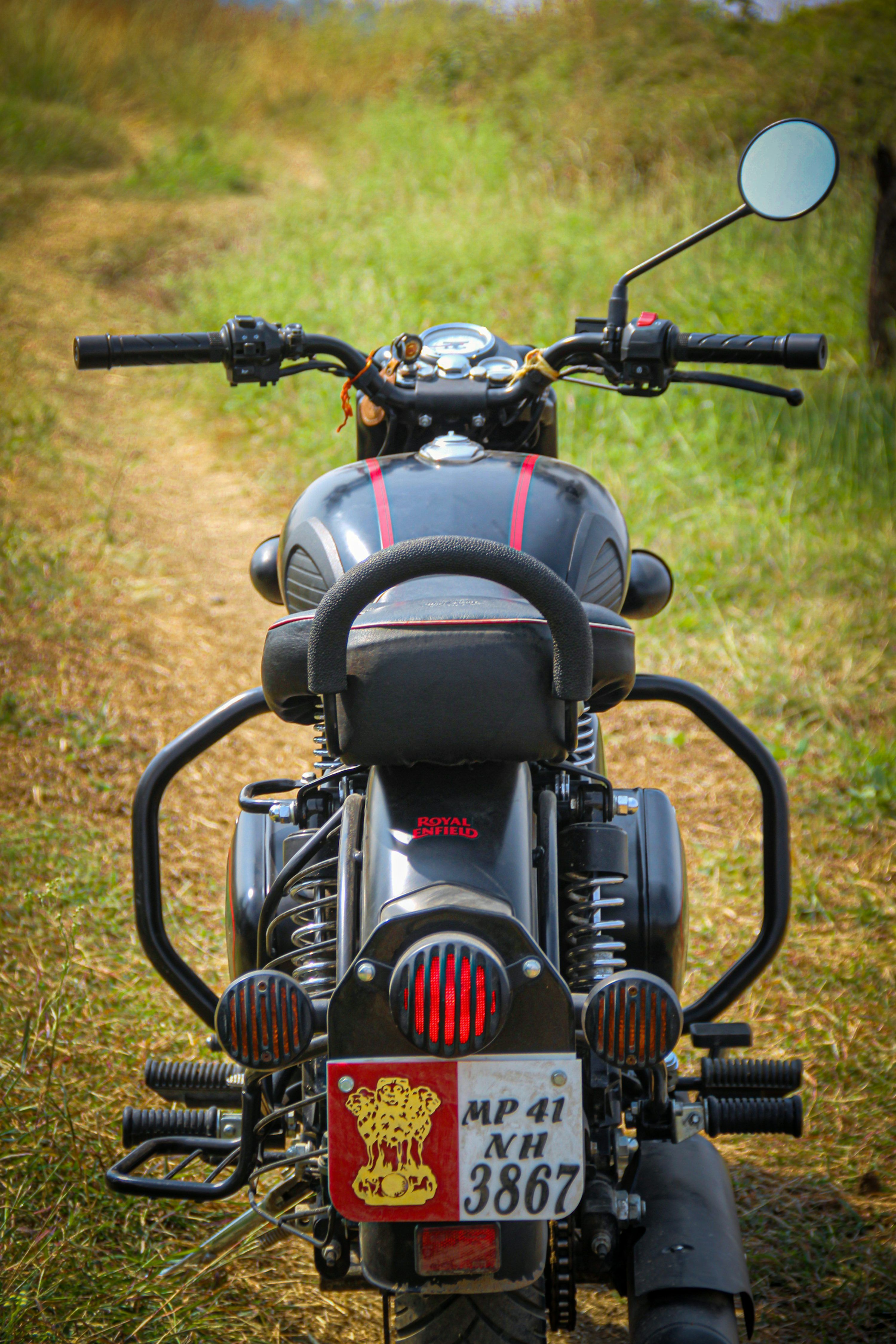 3000x4499 A motorcycle parked on the side of a dirt road