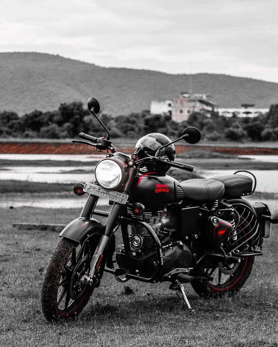 1080x1350 Download a black motorcycle parked in a grassy field Picture