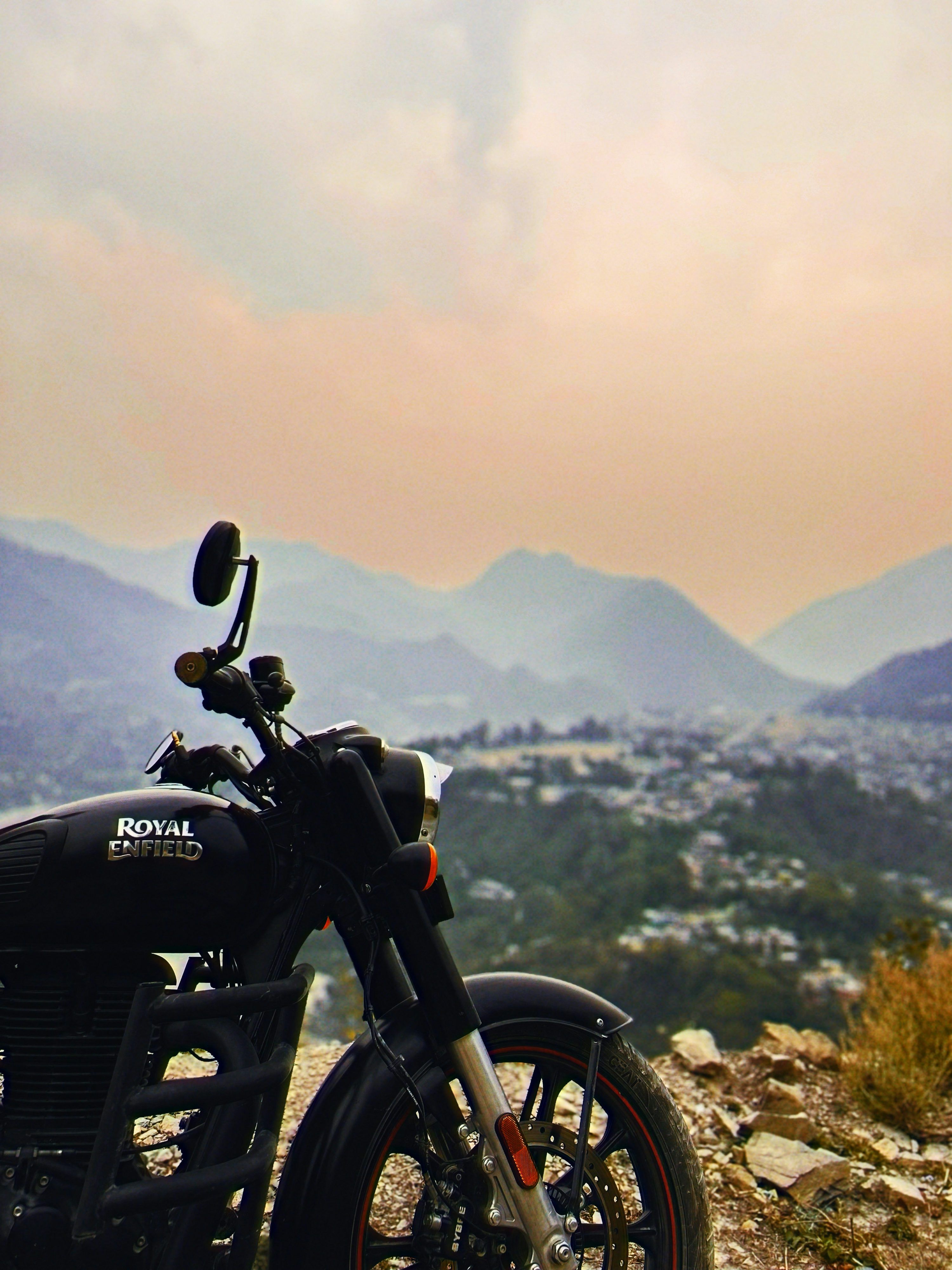 3000x4000 A motorcycle is parked on a rocky hill