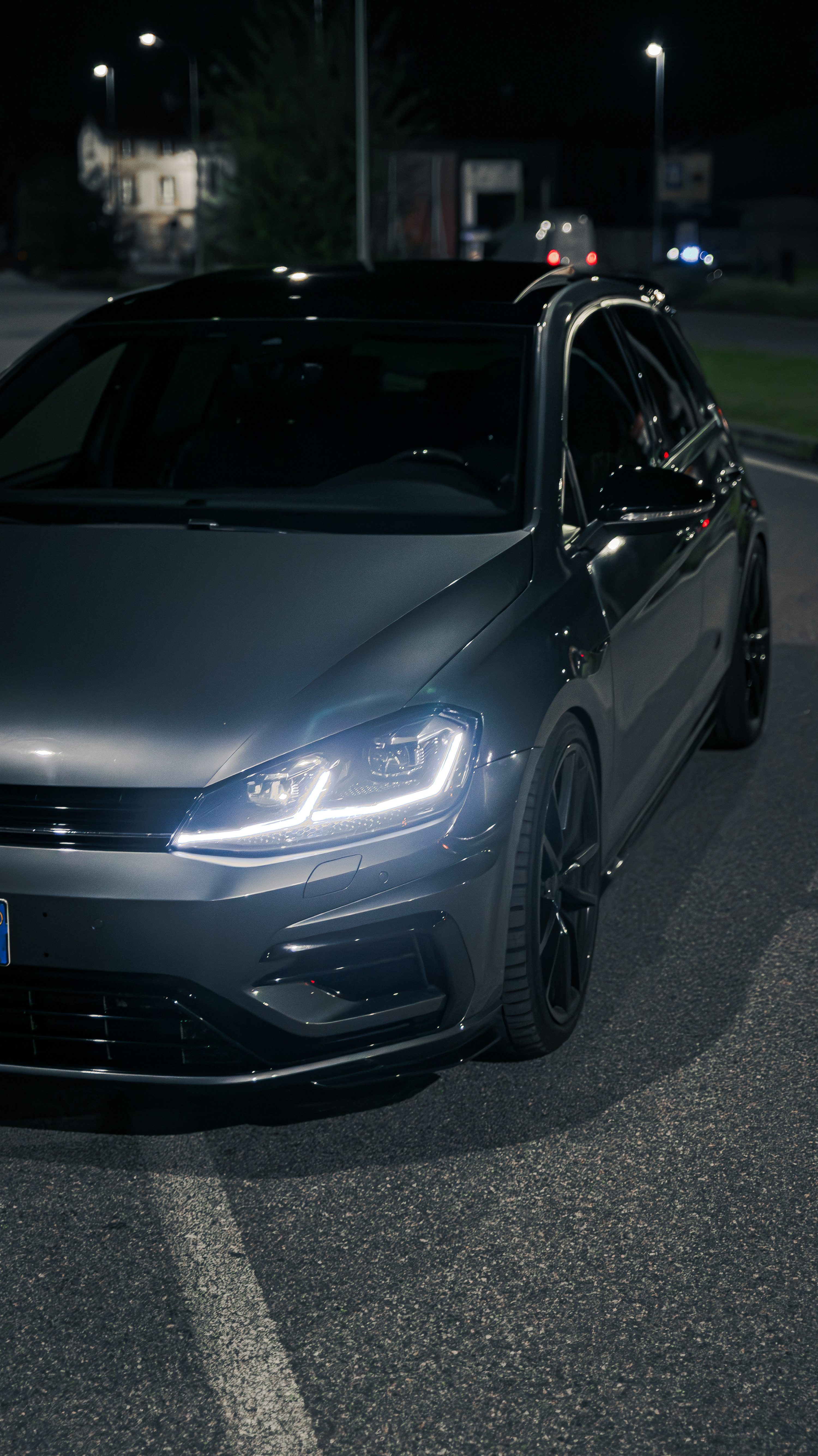 3000x5343 A car parked on the side of the road at night