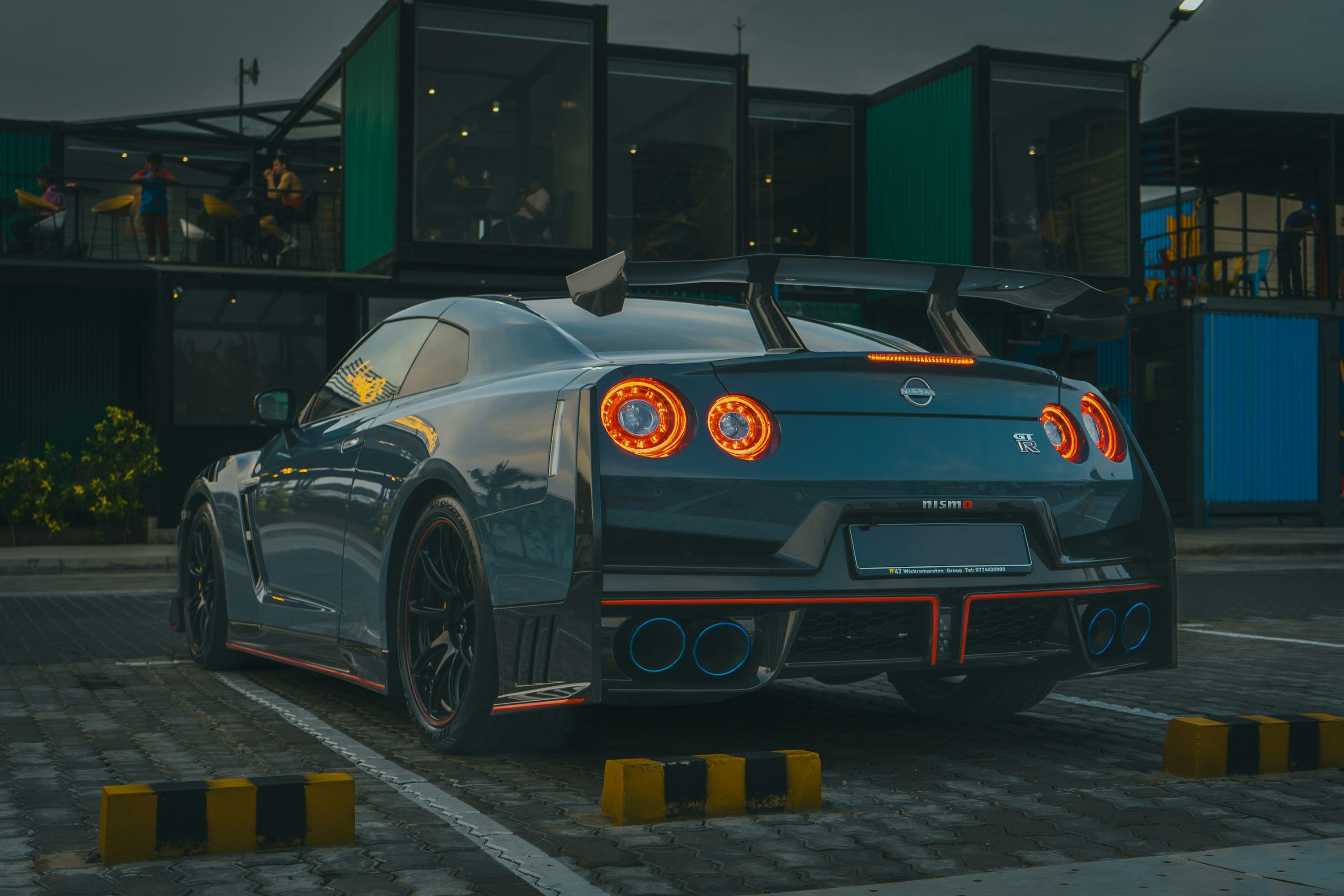 3000x2000 A dark blue nissan gtr parked at dusk