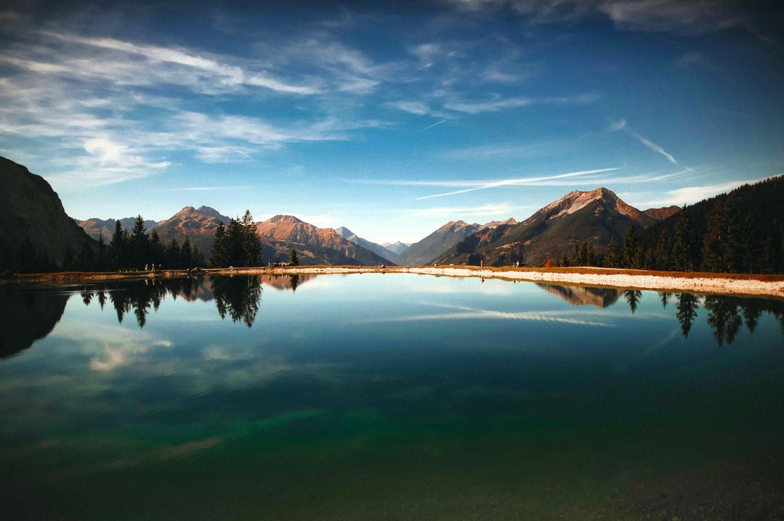 1129x750 Body of Water Near Mountain · Free