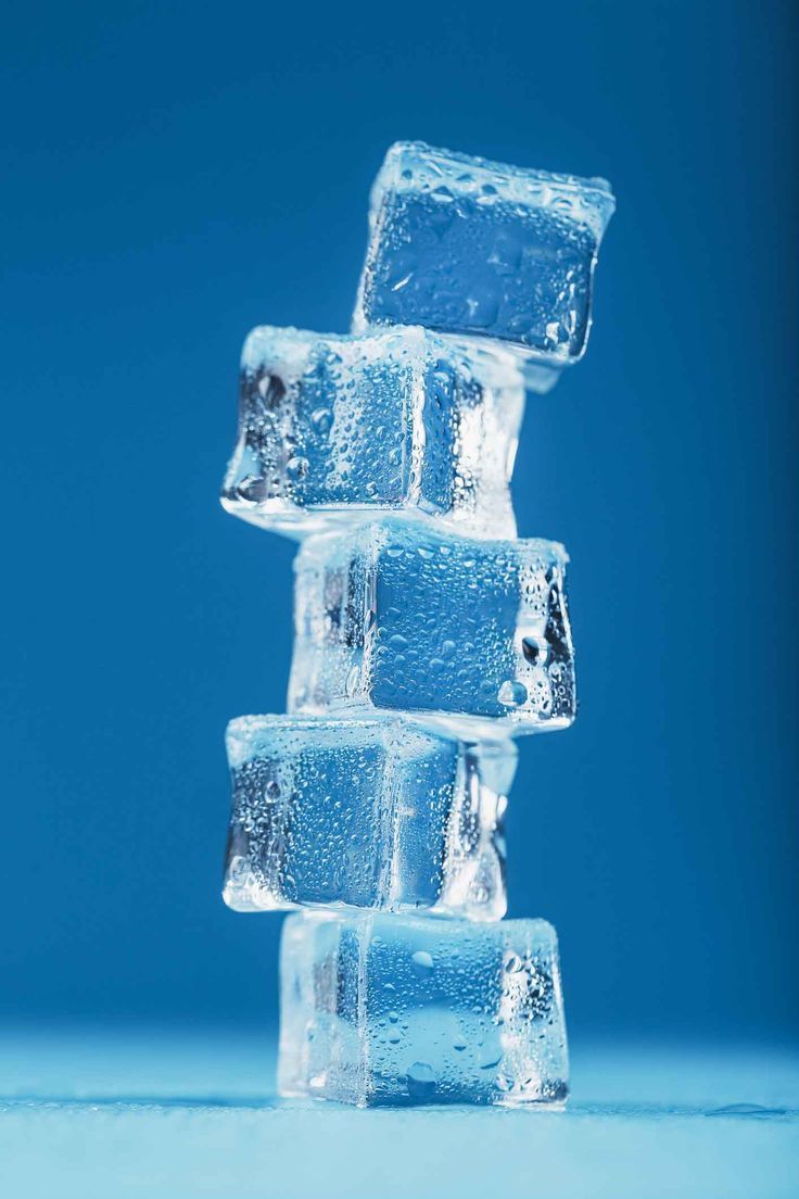 736x1104 Frosty ice cubes in the form of a tower on a blue background