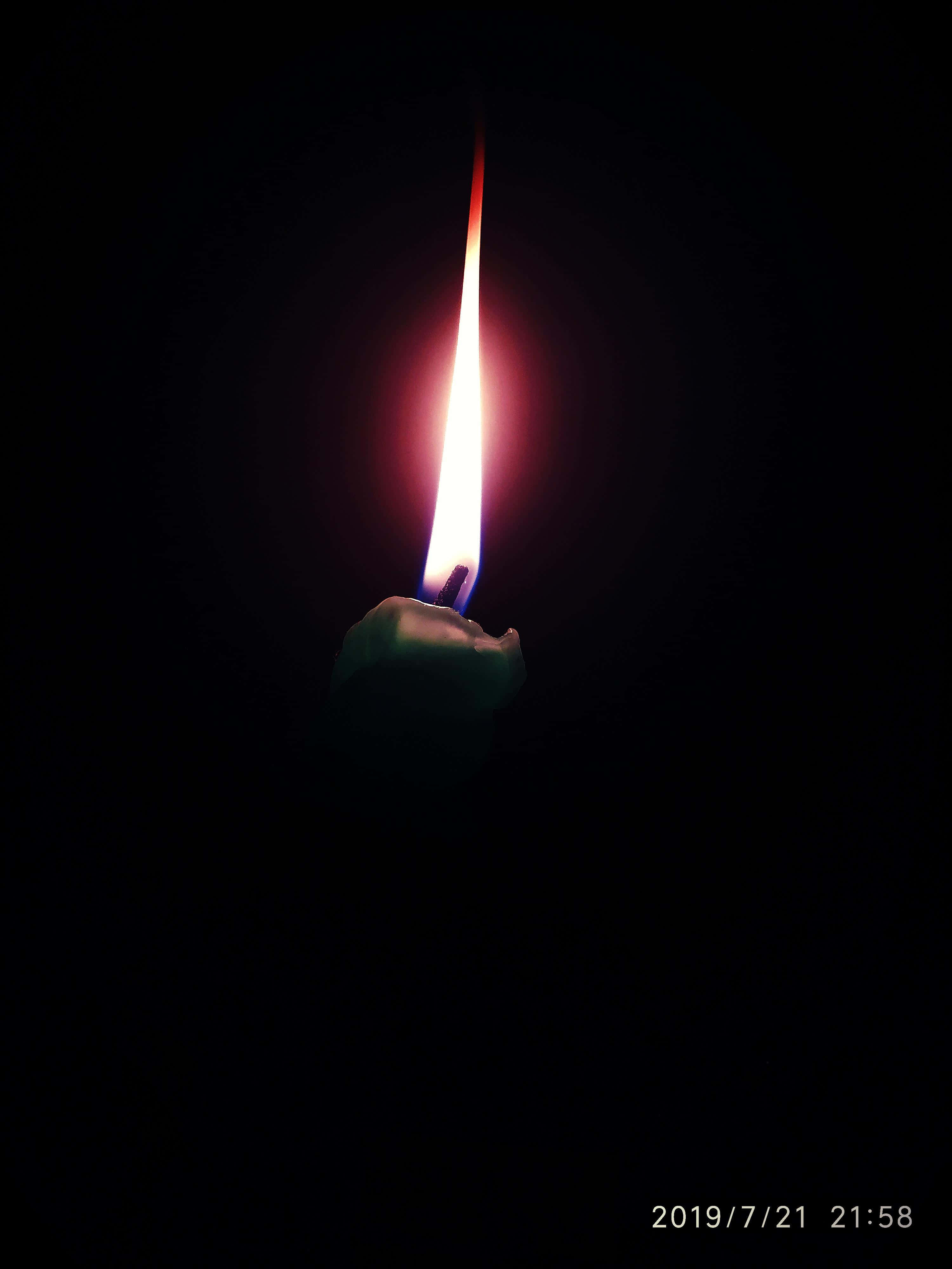 3000x4000 Download a candle lit in the dark with a black background Wallpaper