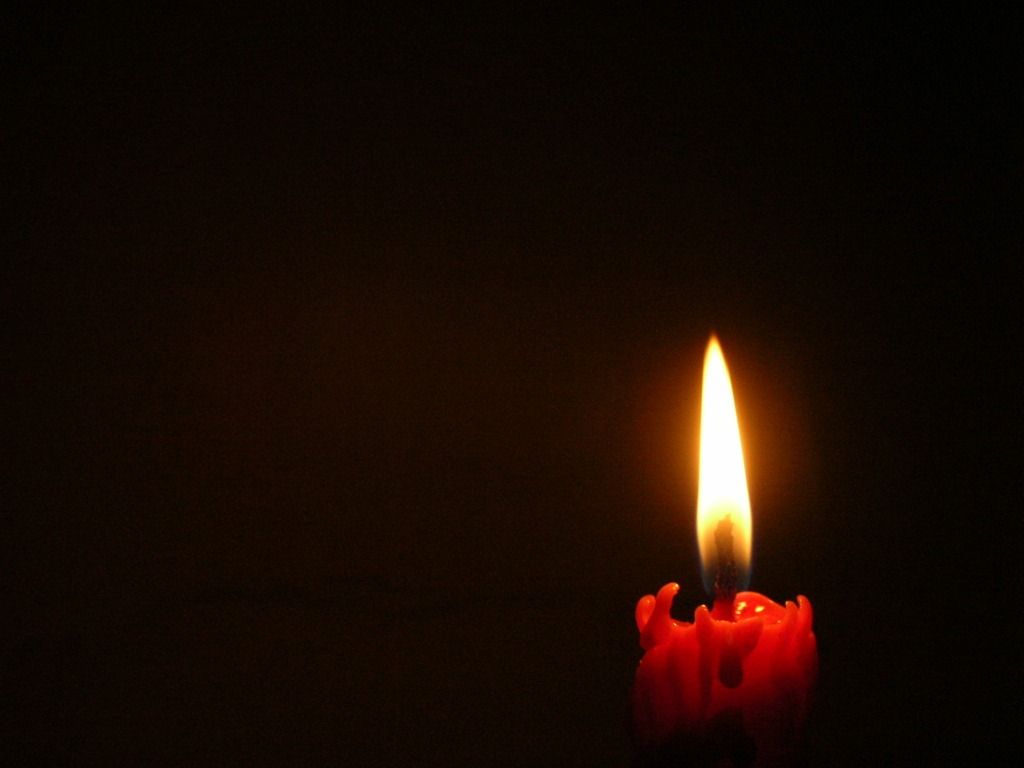 1024x768 Burning candle on black