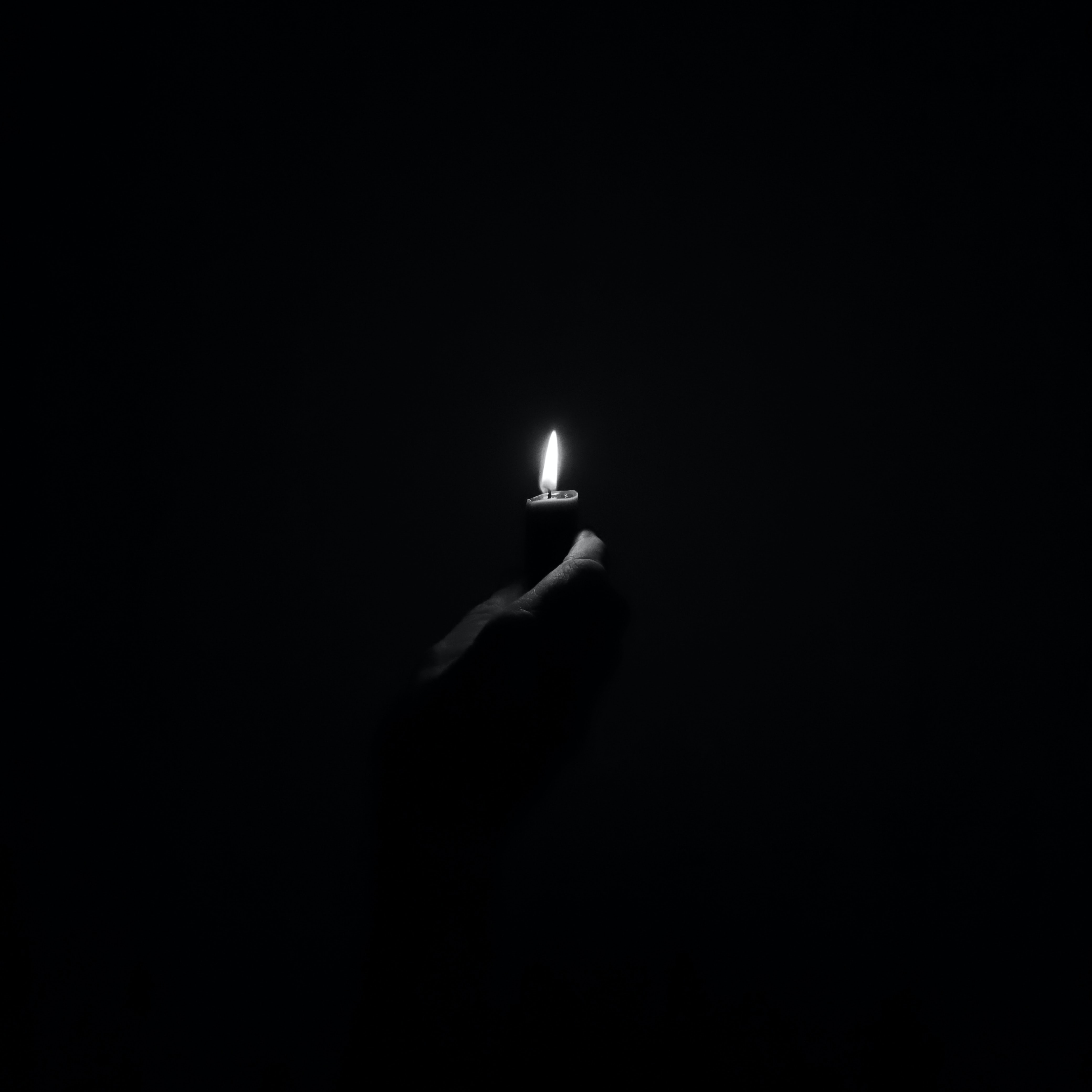 4160x4160 Download wallpaper 4160x4160 candle, fire, light, hand, black and white, black HD background