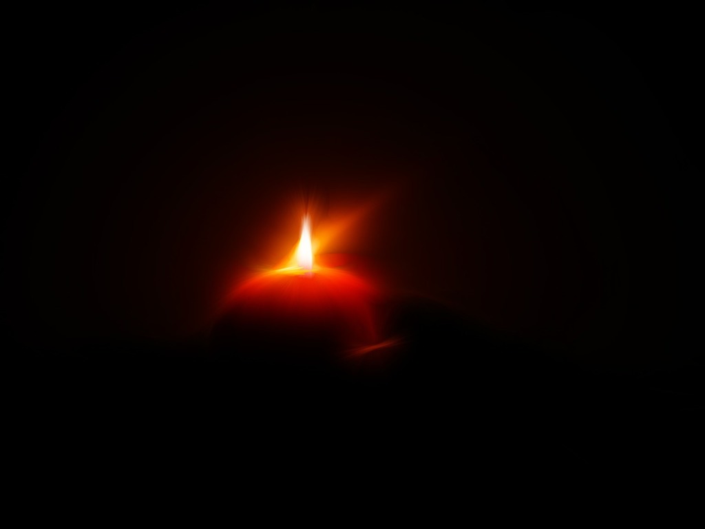 1024x768 A lit candle in the dark on a table. Candle candlelight