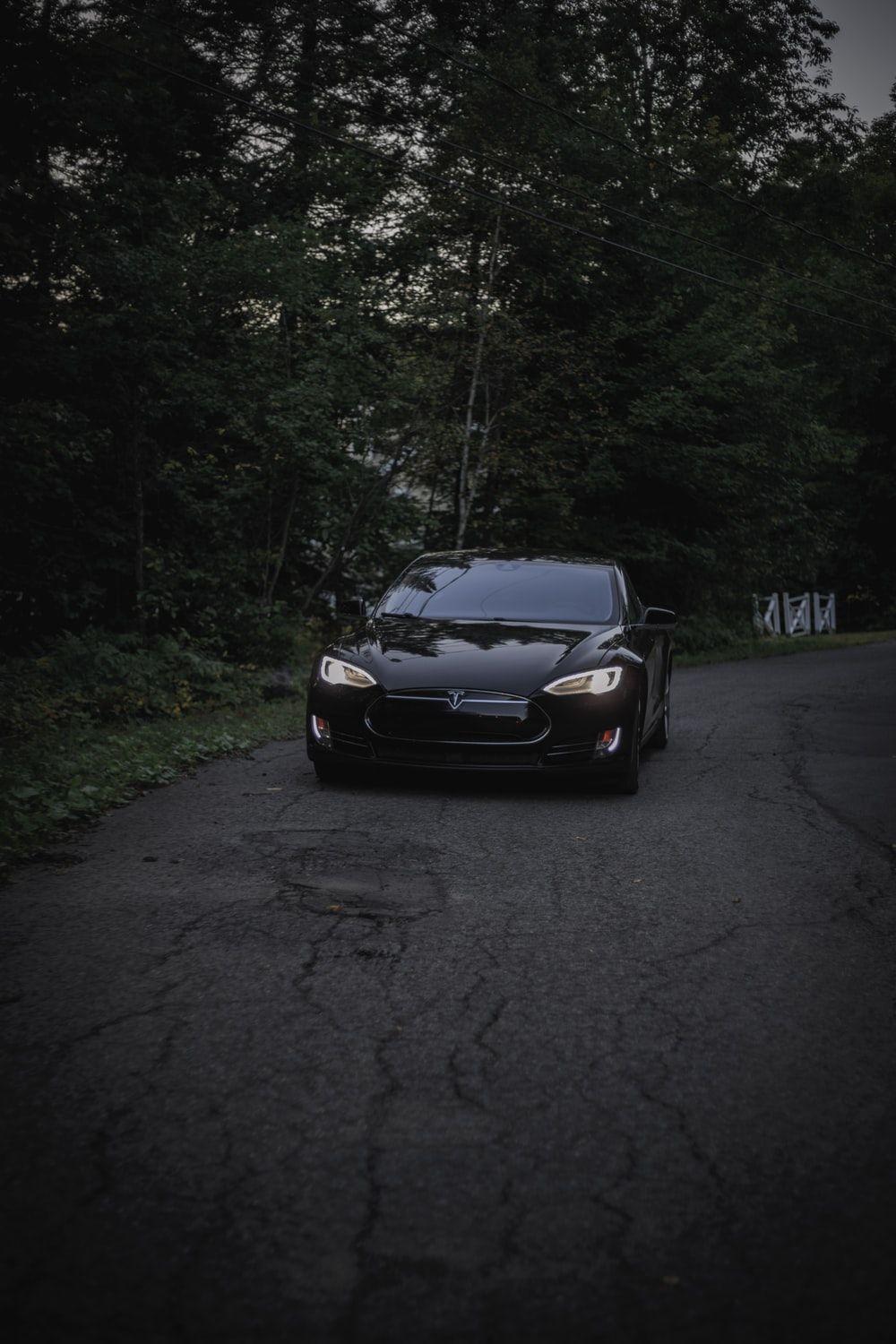 1000x1500 black Tesla Model S at nighttime photo