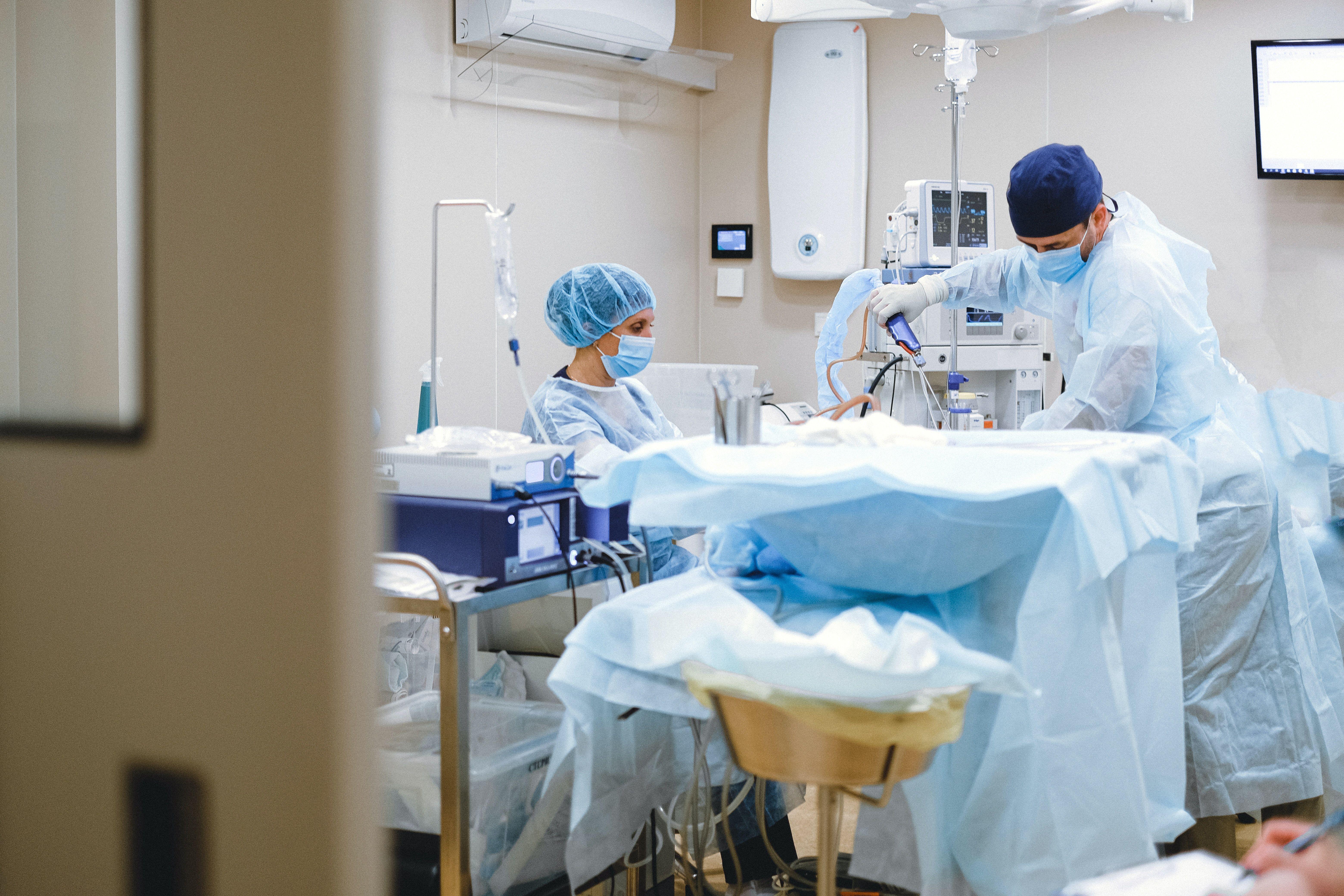 6240x4160 Man in White Medical Scrub Suit Standing Near White Hospital Bed · Free