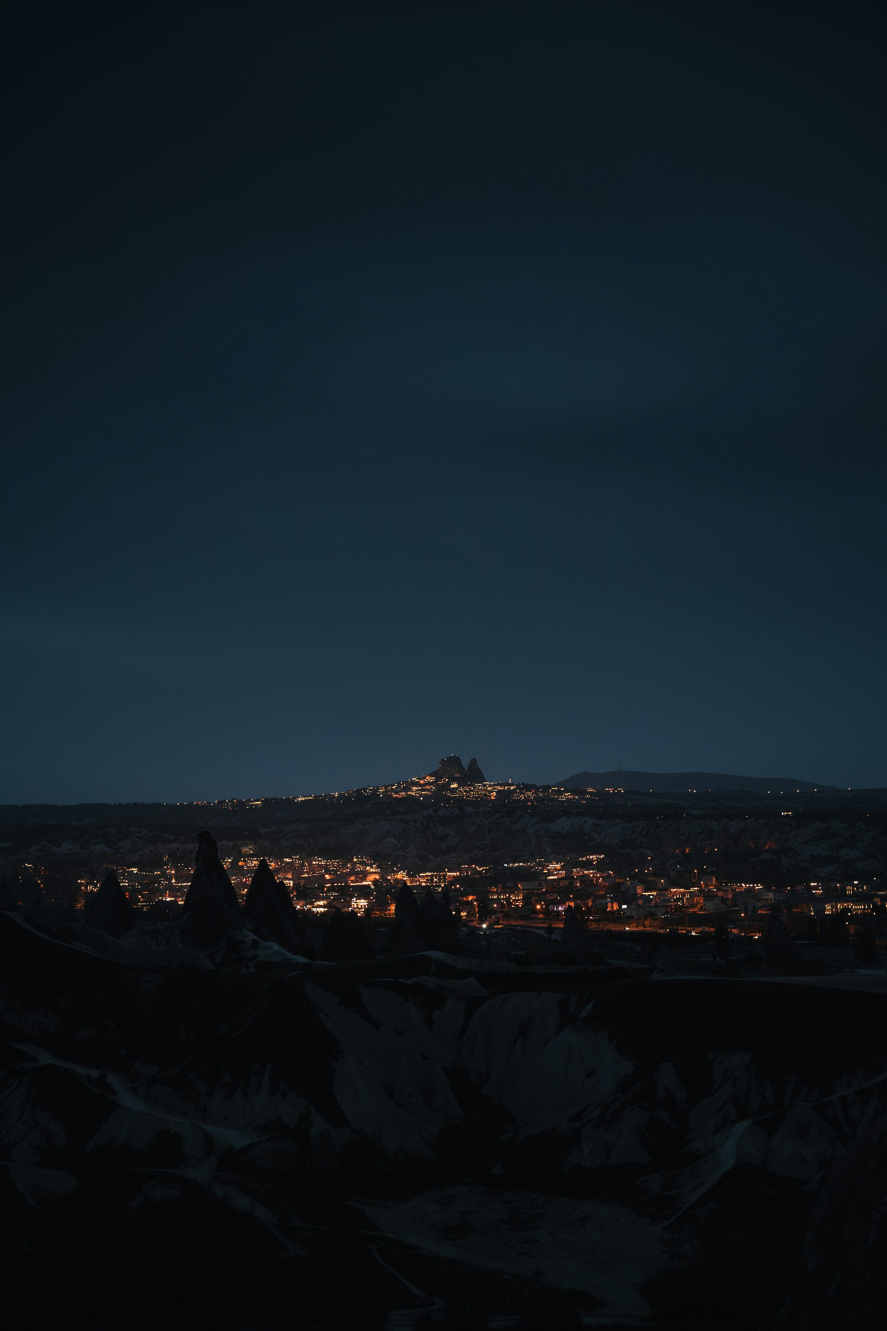 3000x4500 A view of a city at night from the top of a hill