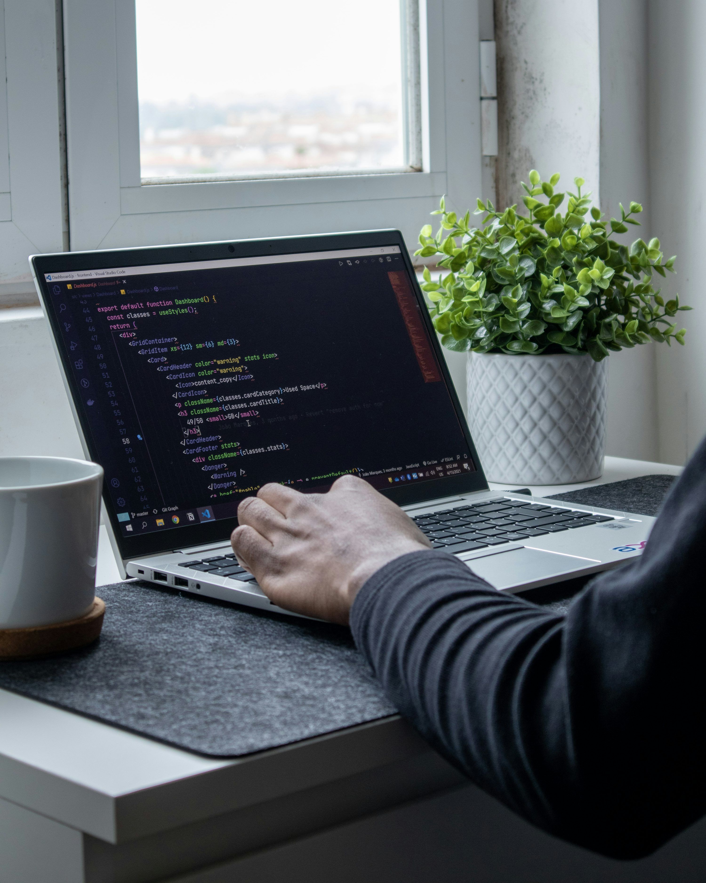 3000x3750 Person coding on laptop workspace