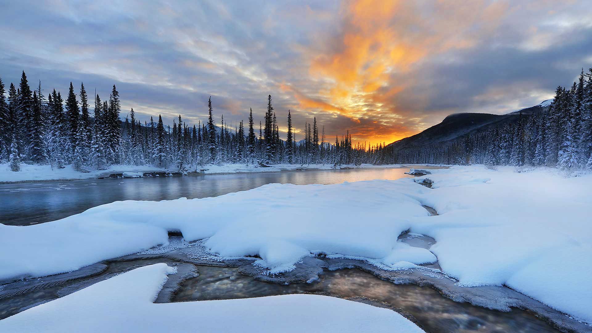 1920x1080 Desktop wallpaper: Winter, River, Mountain, Snow, Canada, Earth, Alberta, Banff National Park, Forest, Landscape, Nature, Sky 4K free download for PC. 737942