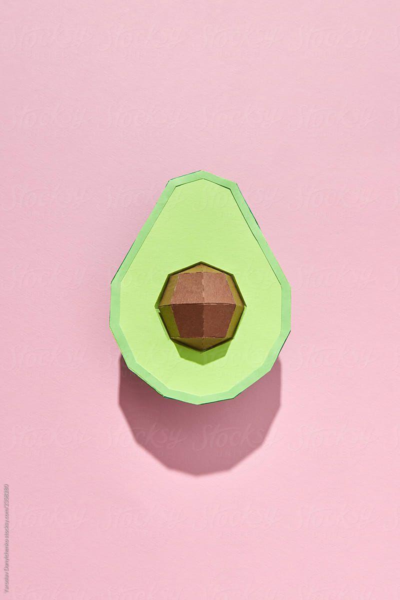 800x1200 Handcraft green avocado with bone made of paper presented on a coral background with space for