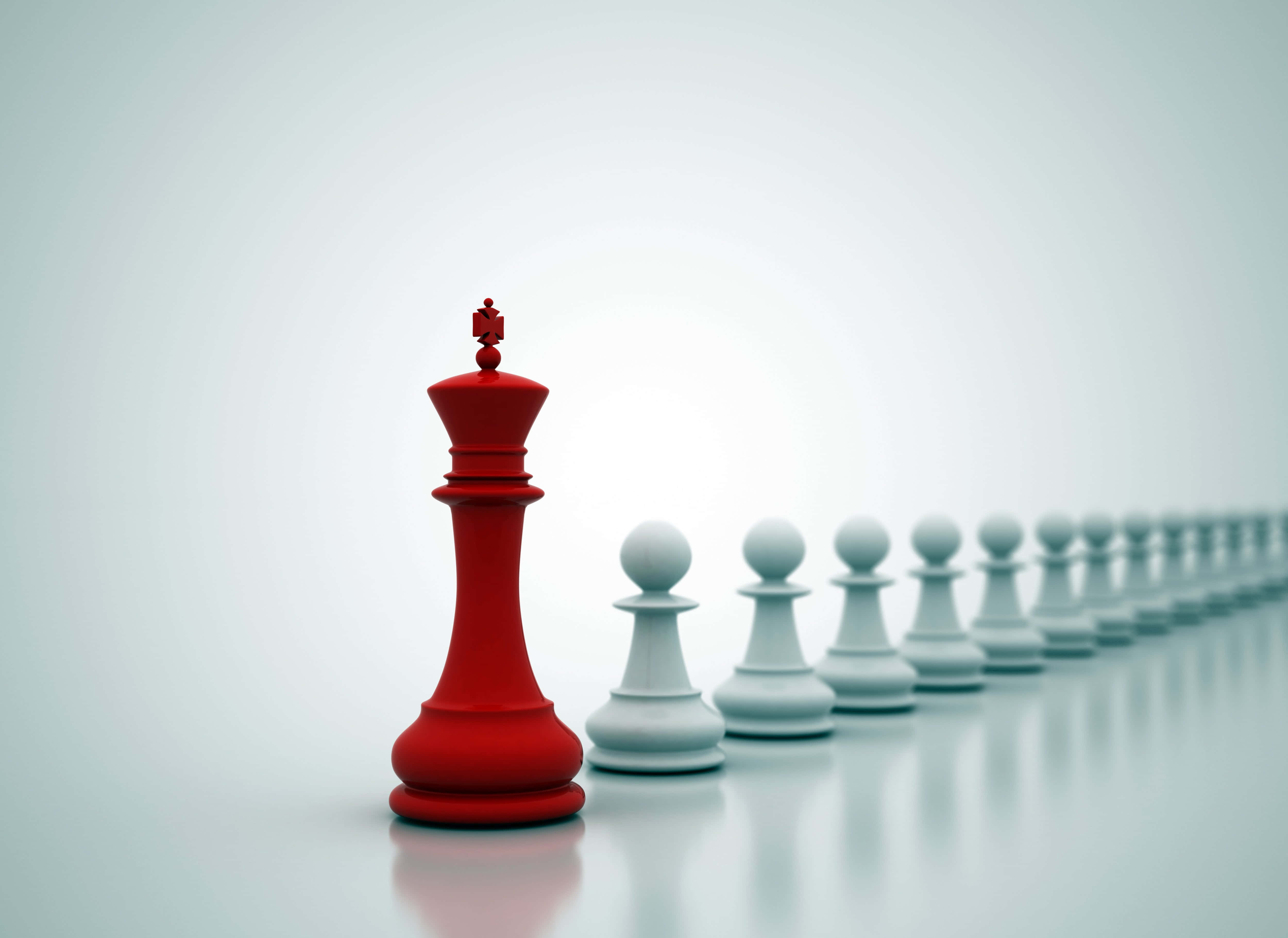 5000x3643 Download a red chess piece is standing in the middle of a row of white chess pieces Picture