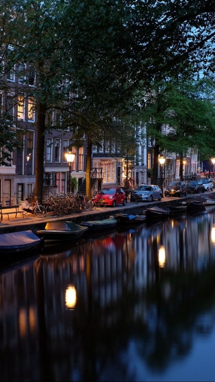 750x1334 Phone wallpaper: Netherlands, Man Made, Amsterdam, River, City, Reflection, Light, Night, Cities 1084778