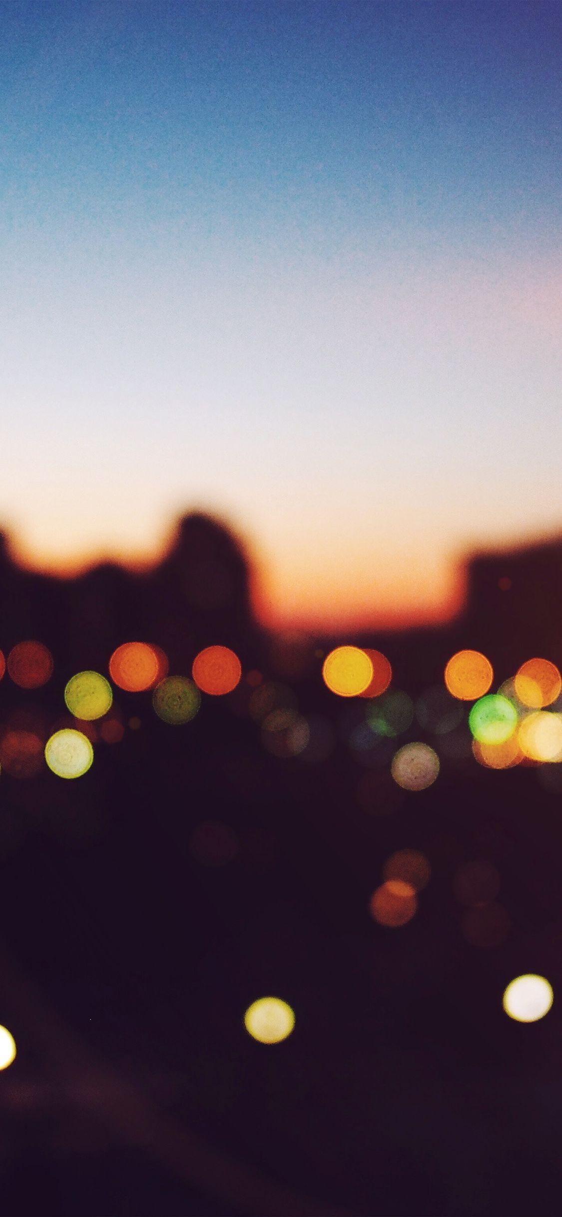 1125x2436 iPhone wallpaper. light bokeh sunset city flare