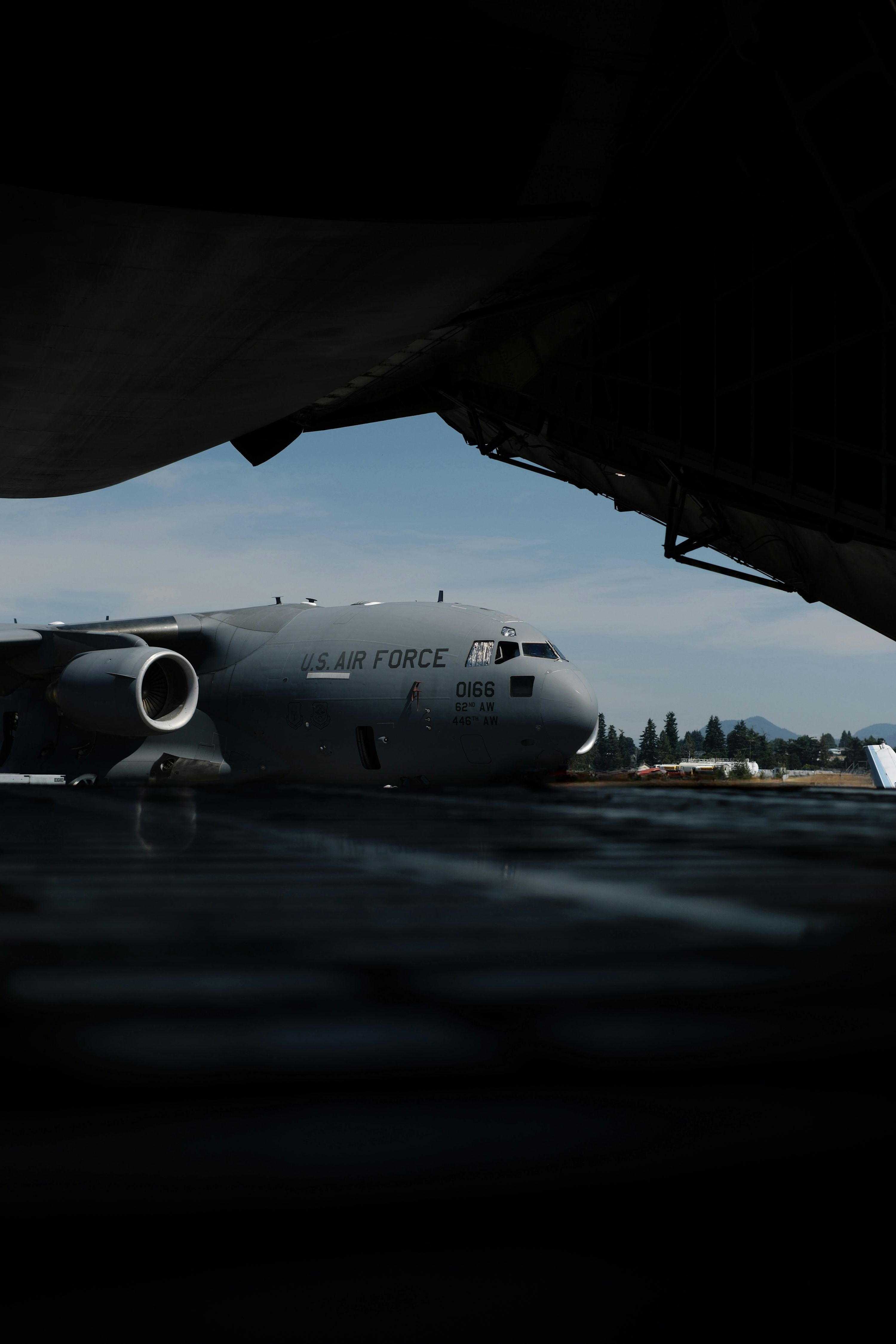 3000x4500 Cargo plane parked on tarmac under wing