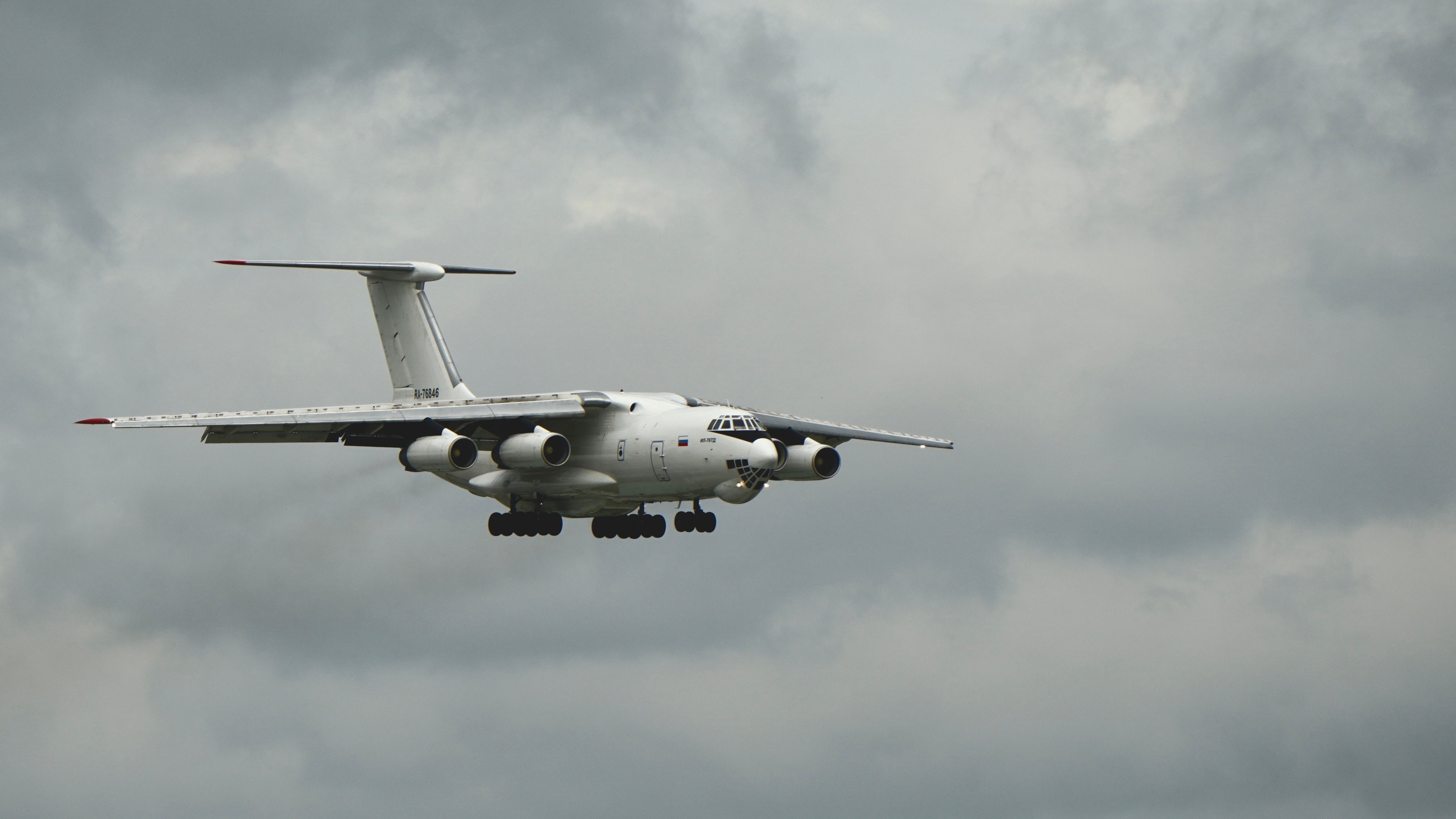 5221x2937 Large Cargo Aircraft in Flight Against Cloudy Sky · Free
