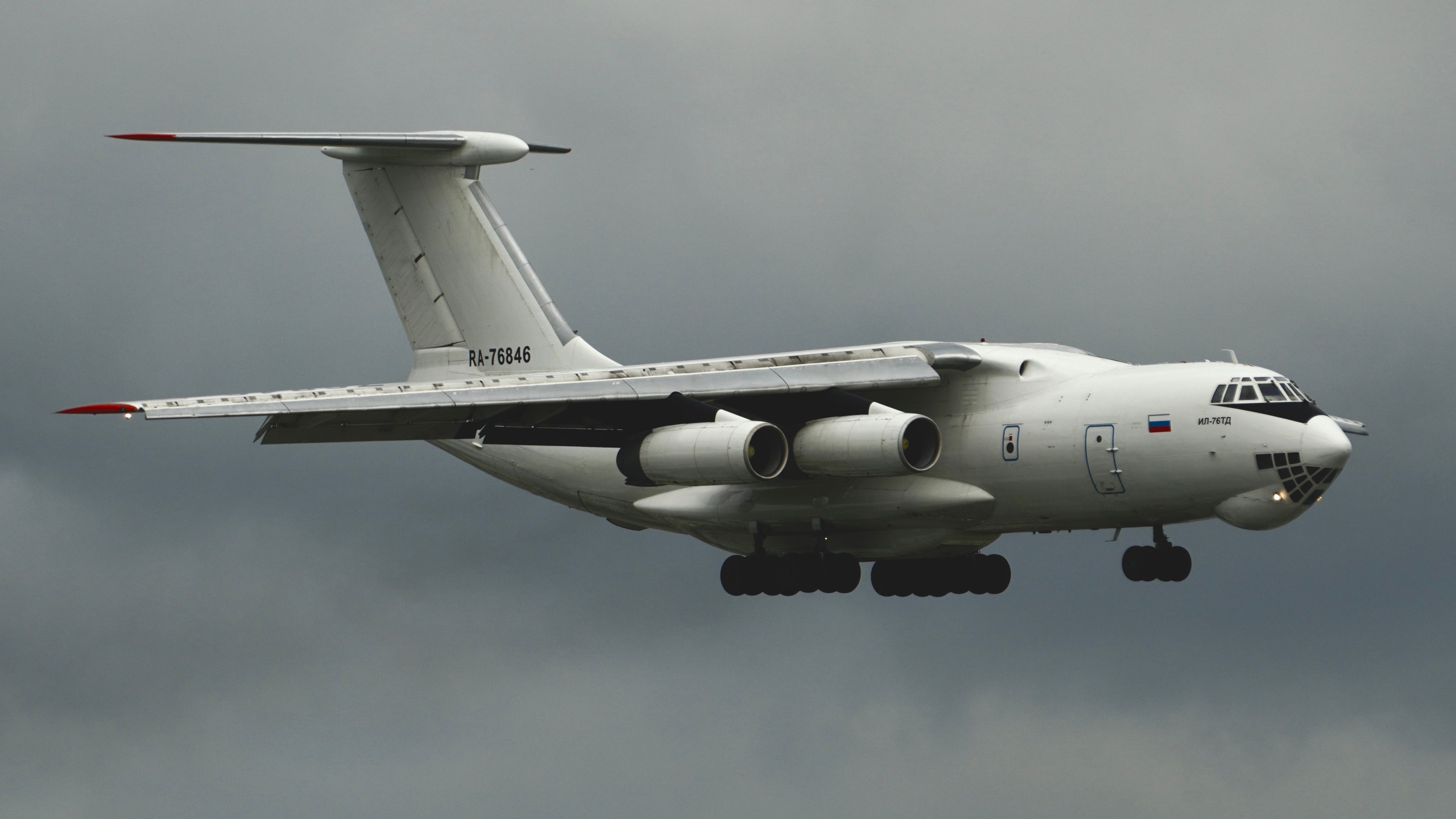 4290x2413 Military Cargo Plane in Flight Under Cloudy Sky · Free