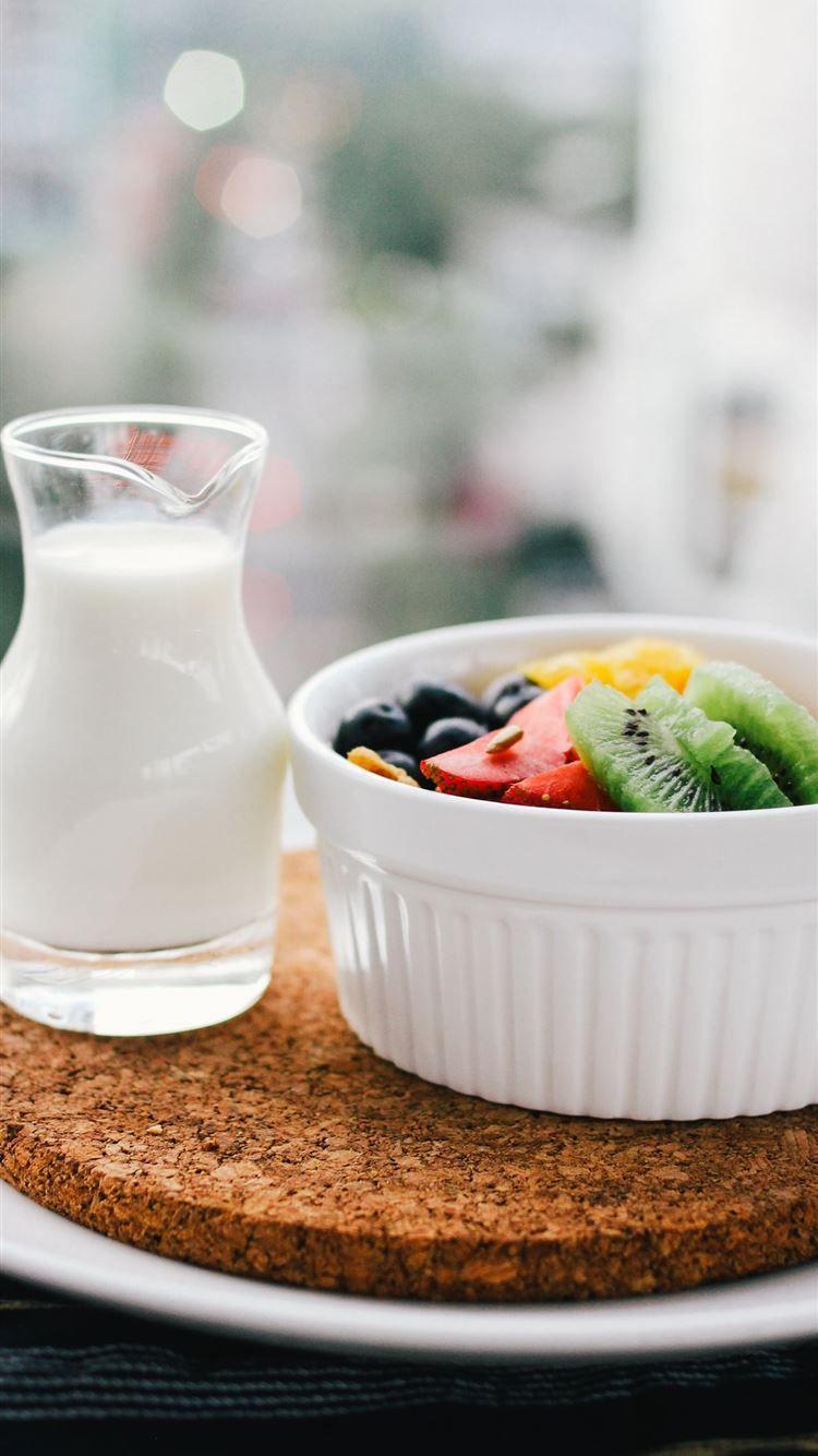 750x1334 fruit salad inside bowl beside glass of milk on br. iPhone 8 Wallpaper Free Download