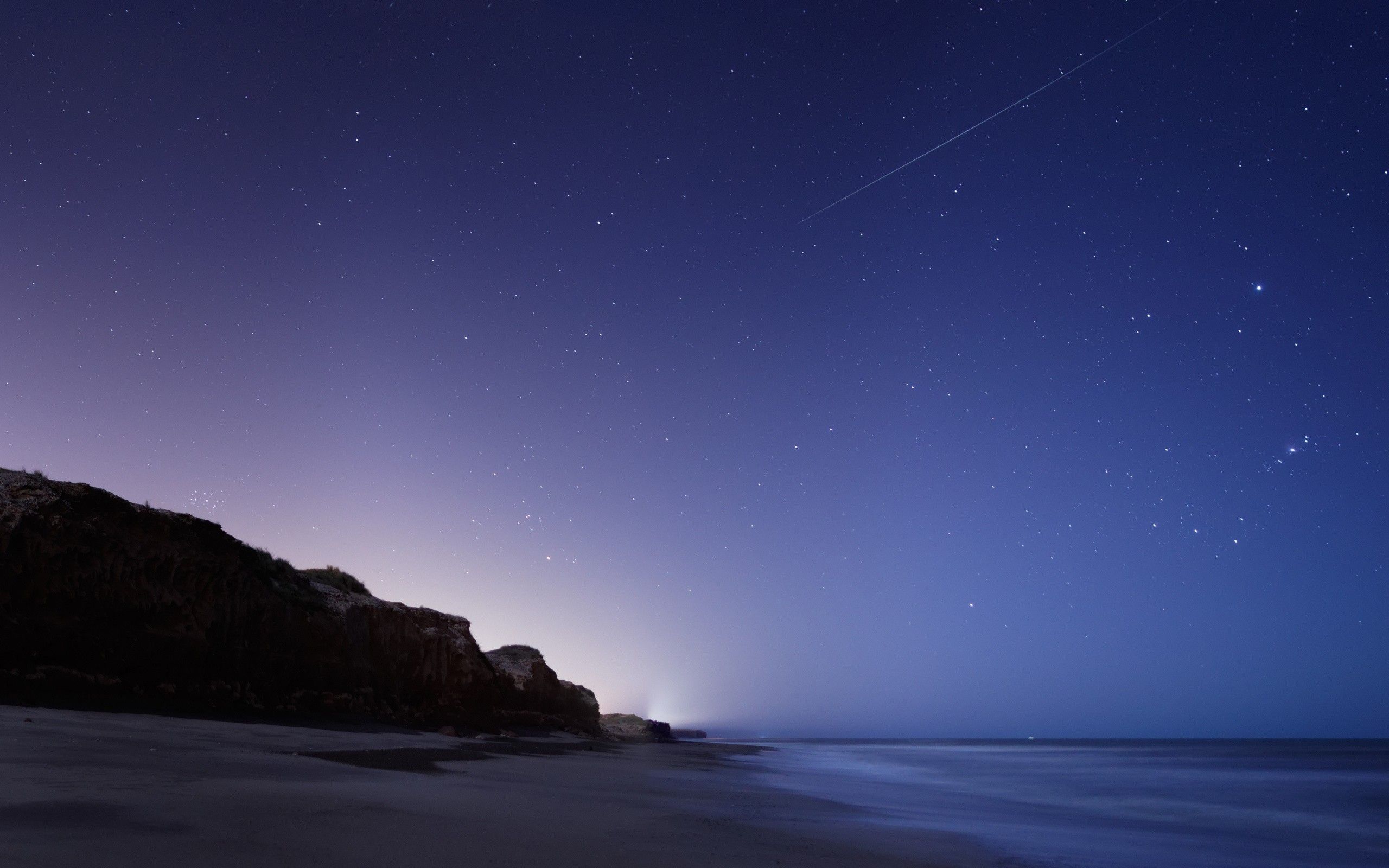 2560x1600 Wallpaper Brown Rock Formation Near Body of Water During Night Time, Background Free Image